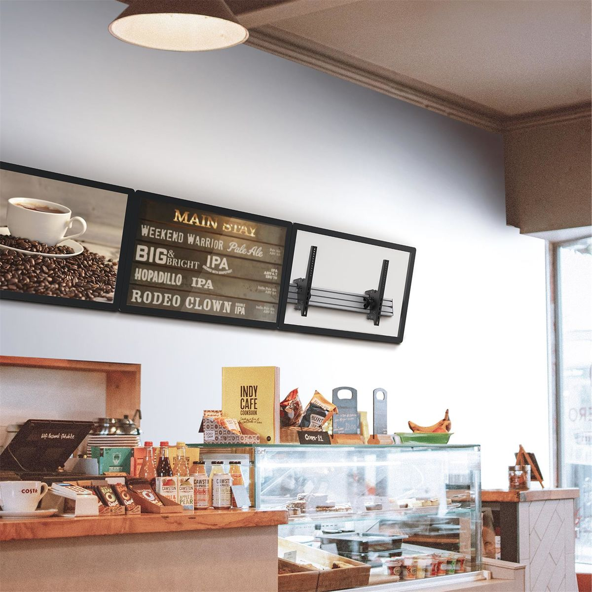 Una escena de cafetería con mostrador, pasteles y una pizarra con texto sobre cervezas.