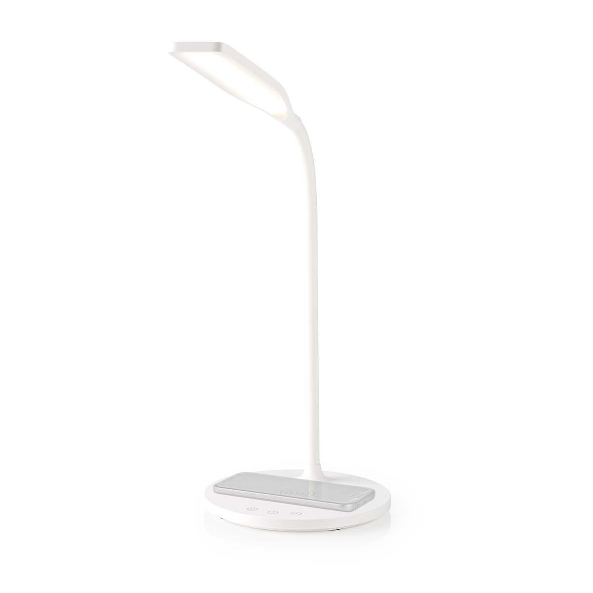 Una lampada da scrivania bianca con base di ricarica wireless.