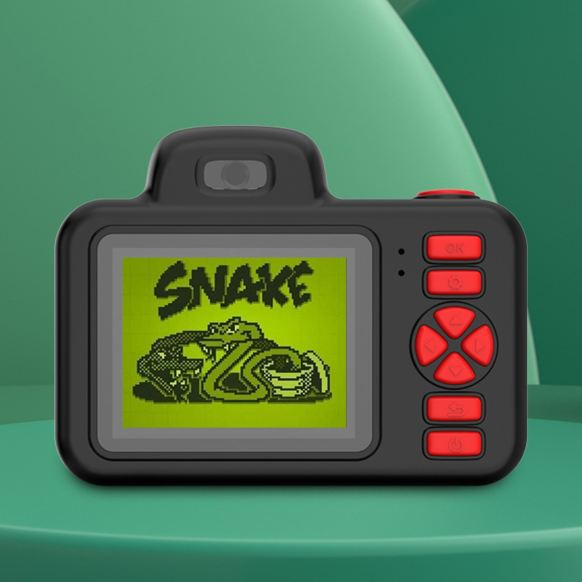 Cámara de juguete negra con pantalla verde que muestra la palabra 'SNAKE' y un juego de serpientes.