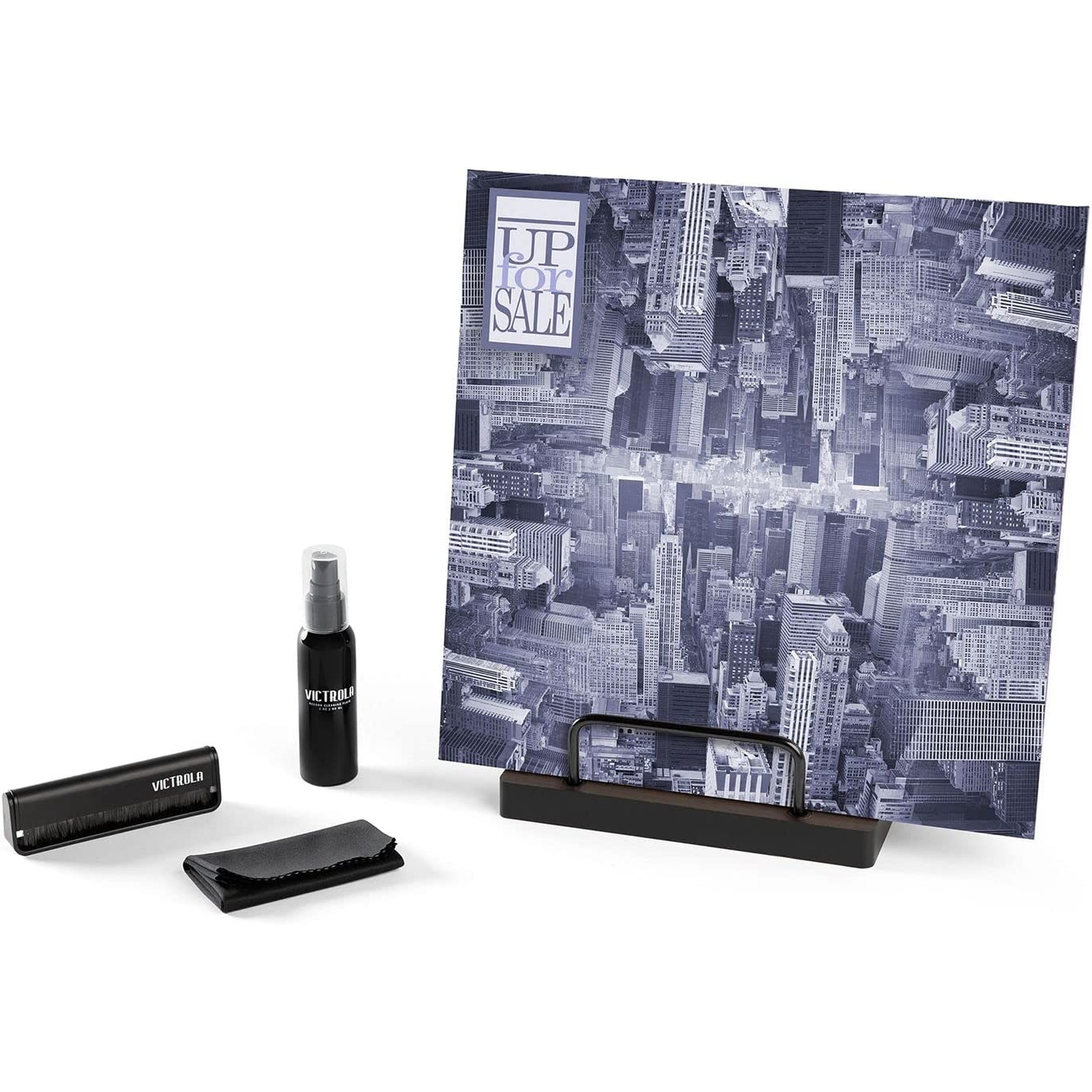 Kit de limpieza de discos y álbum de discos. El álbum muestra un paisaje urbano.