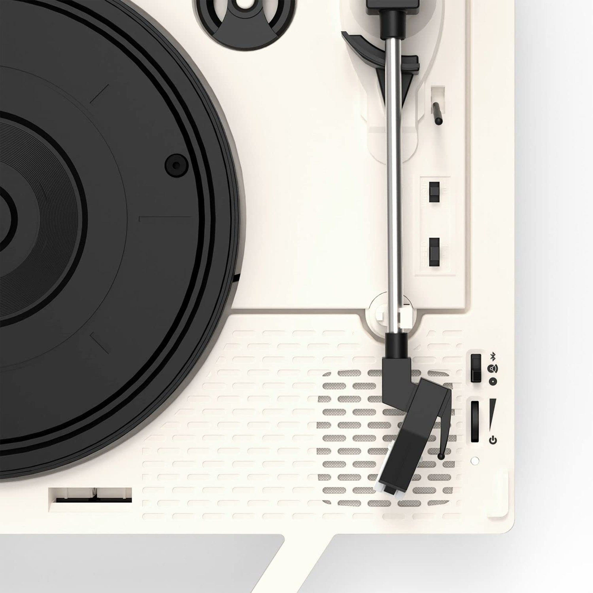 Primer plano de un tocadiscos con disco negro, cuerpo blanco y brazo plateado.