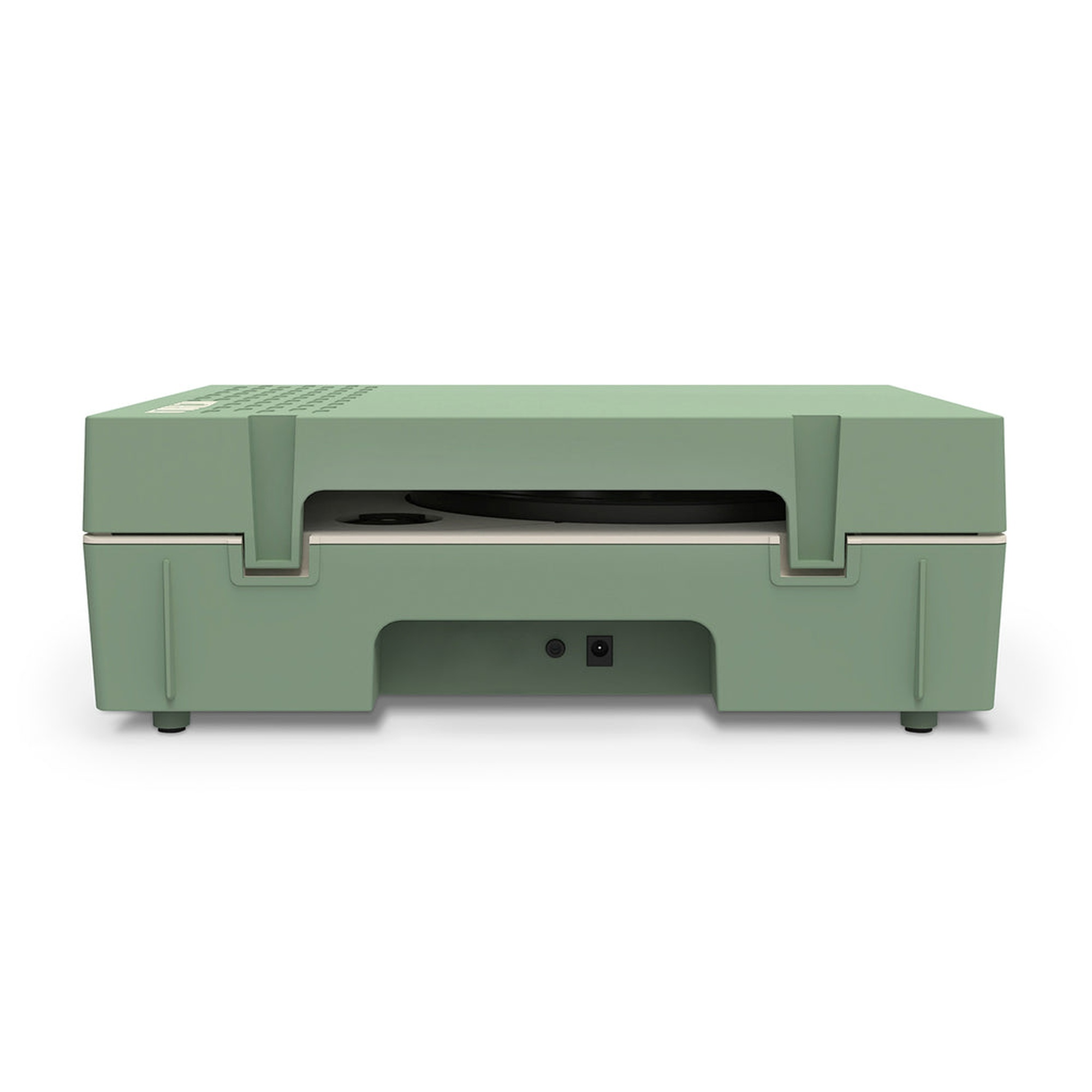 Un dispositivo verde con una ranura. Tiene una entrada de alimentación y está sobre un fondo blanco.
