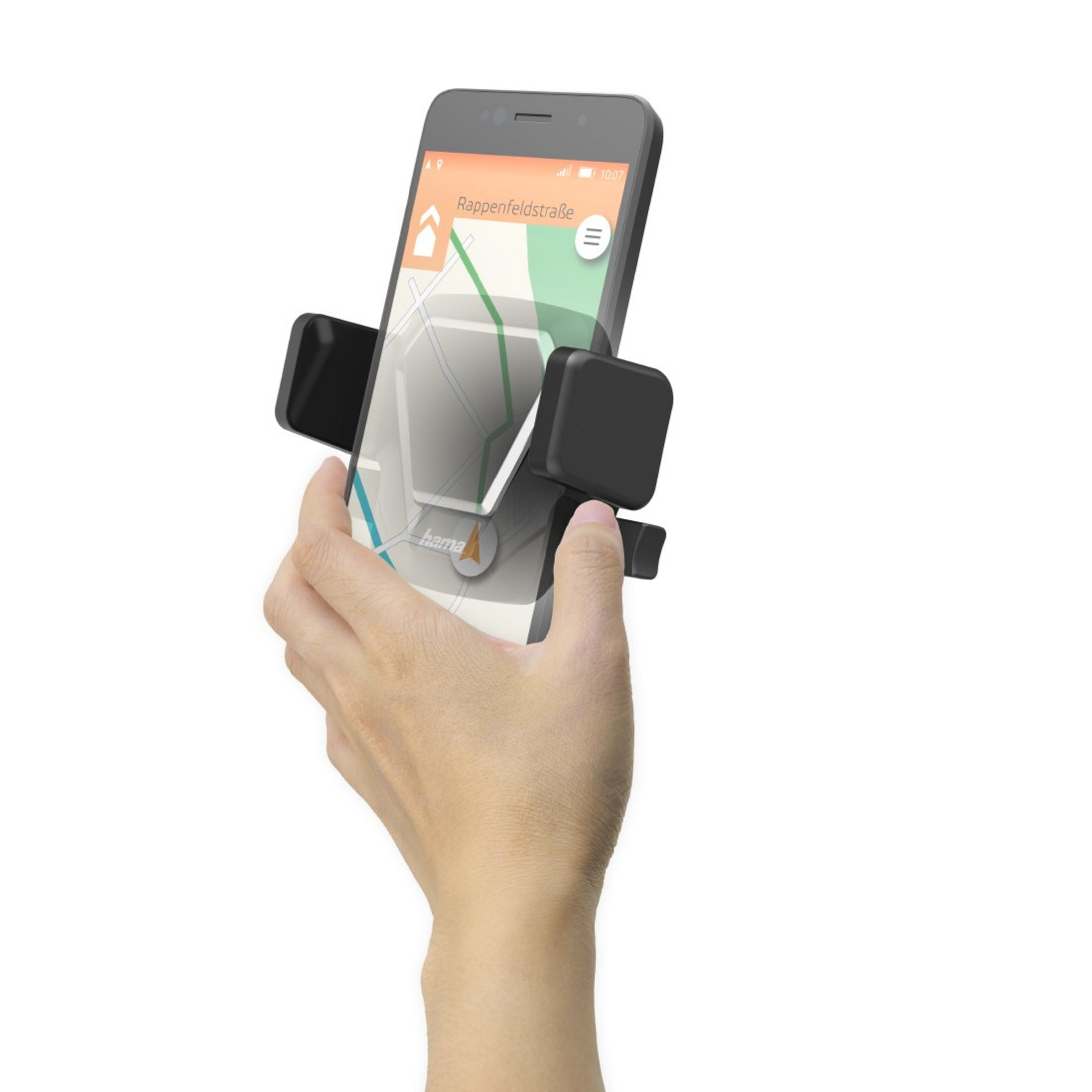 Ręka trzyma telefon w uchwycie samochodowym. Mapa nawigacji widoczna na ekranie.