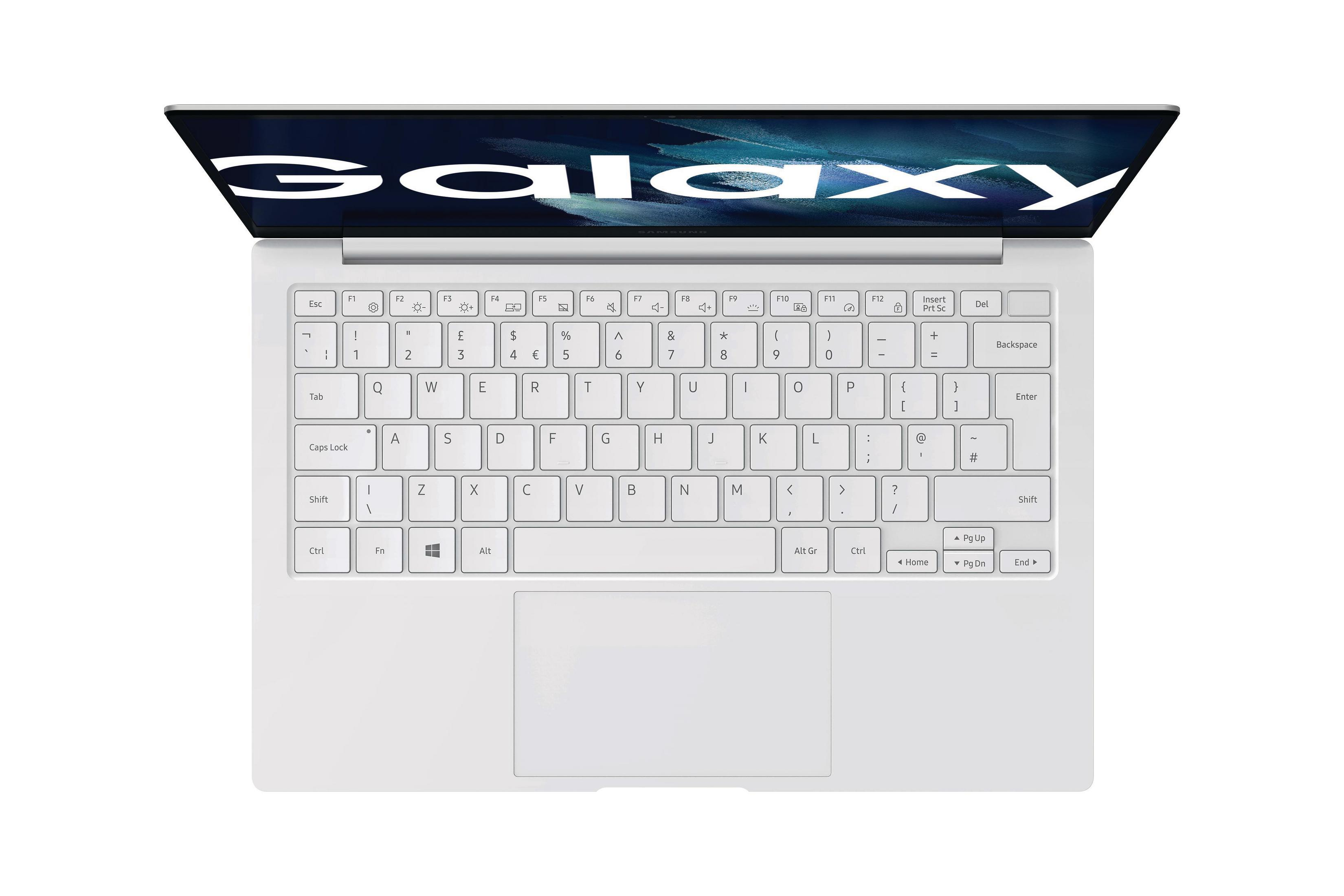Biały laptop ze słowem „GALAXY” na ekranie. Klawiatura jest widoczna.