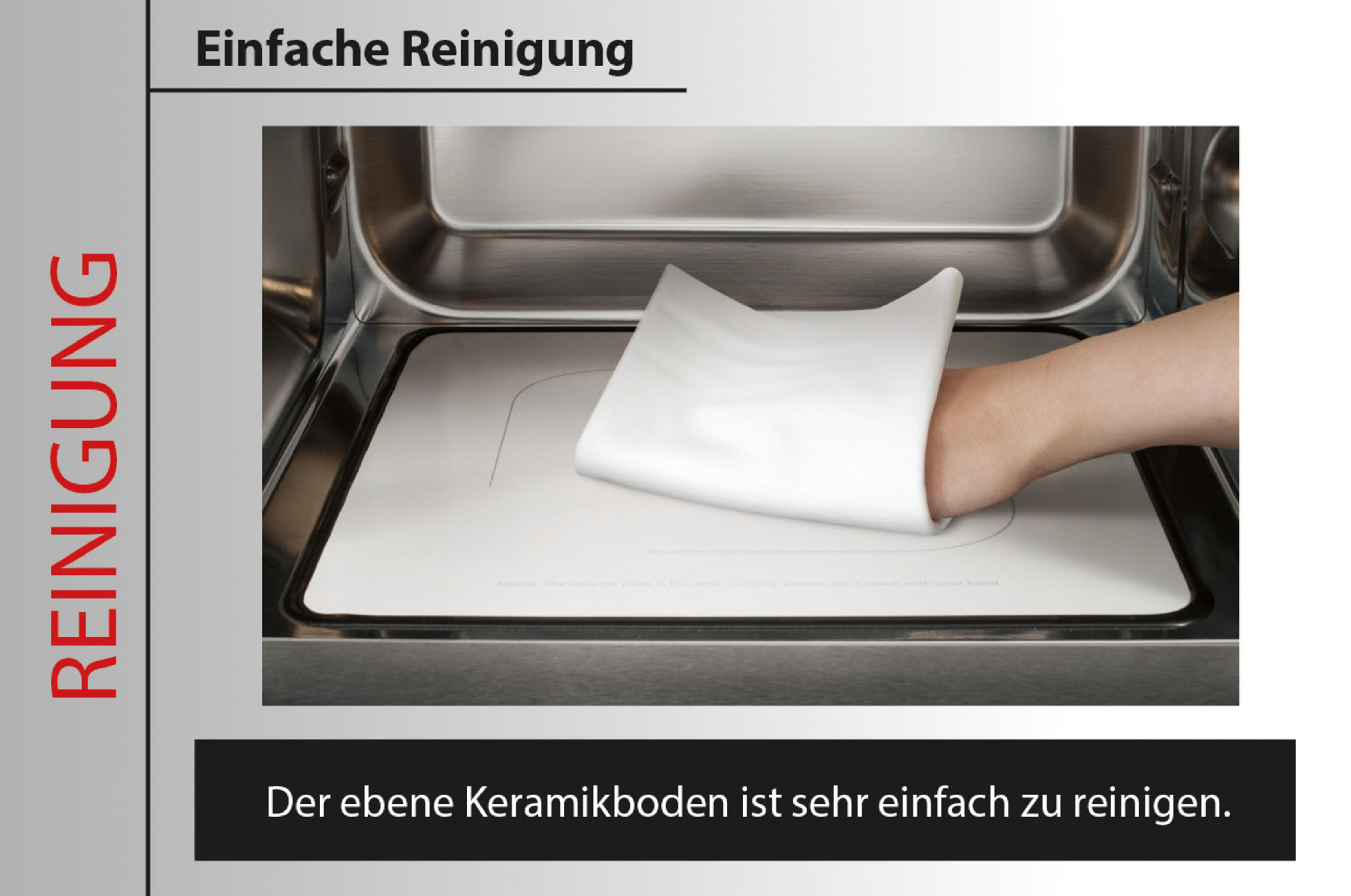 Una mano pulisce una base in ceramica bianca all'interno di un forno a microonde.