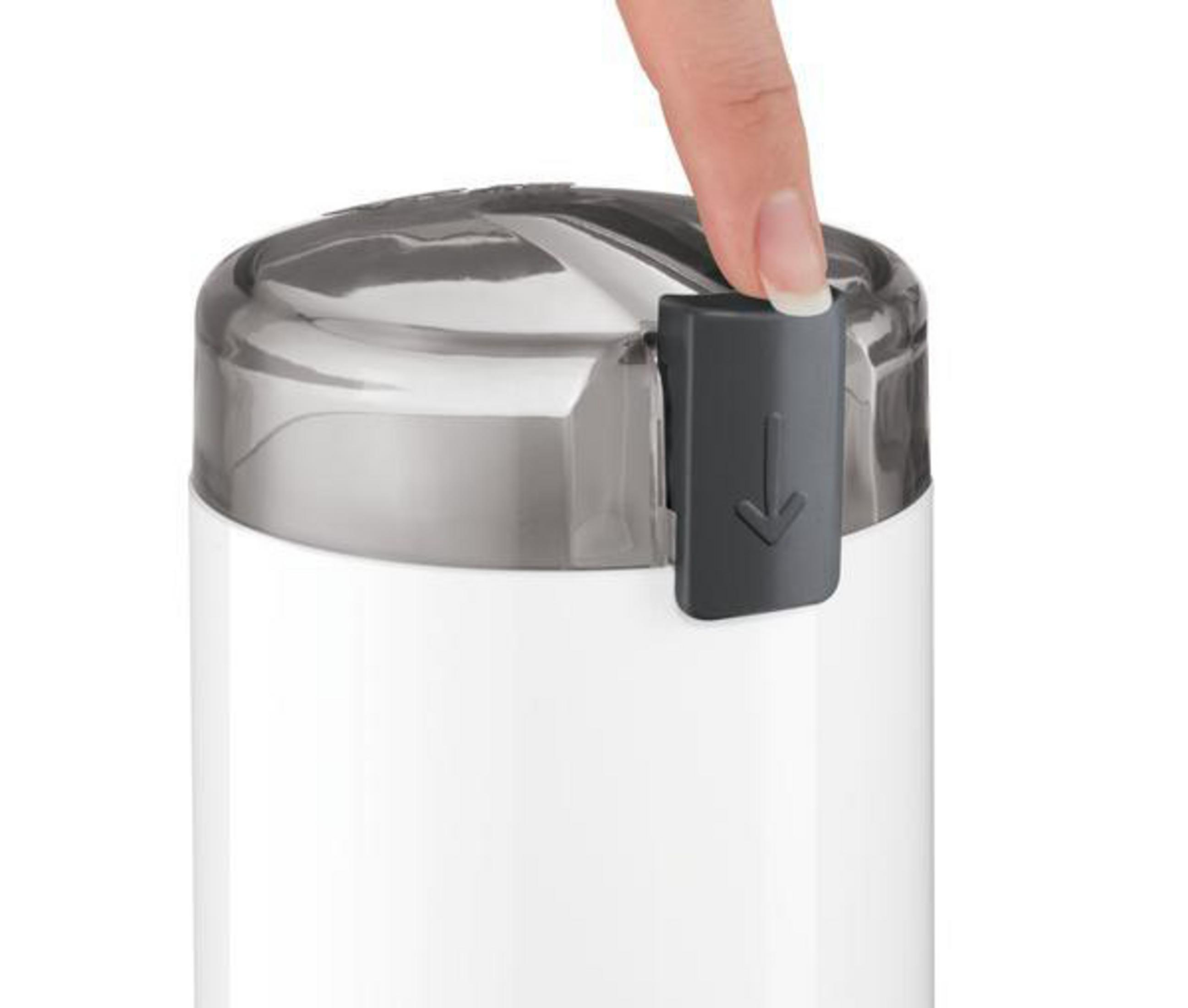 Hand presses a black tab on a white and silver container. Arrow indicates downward direction.