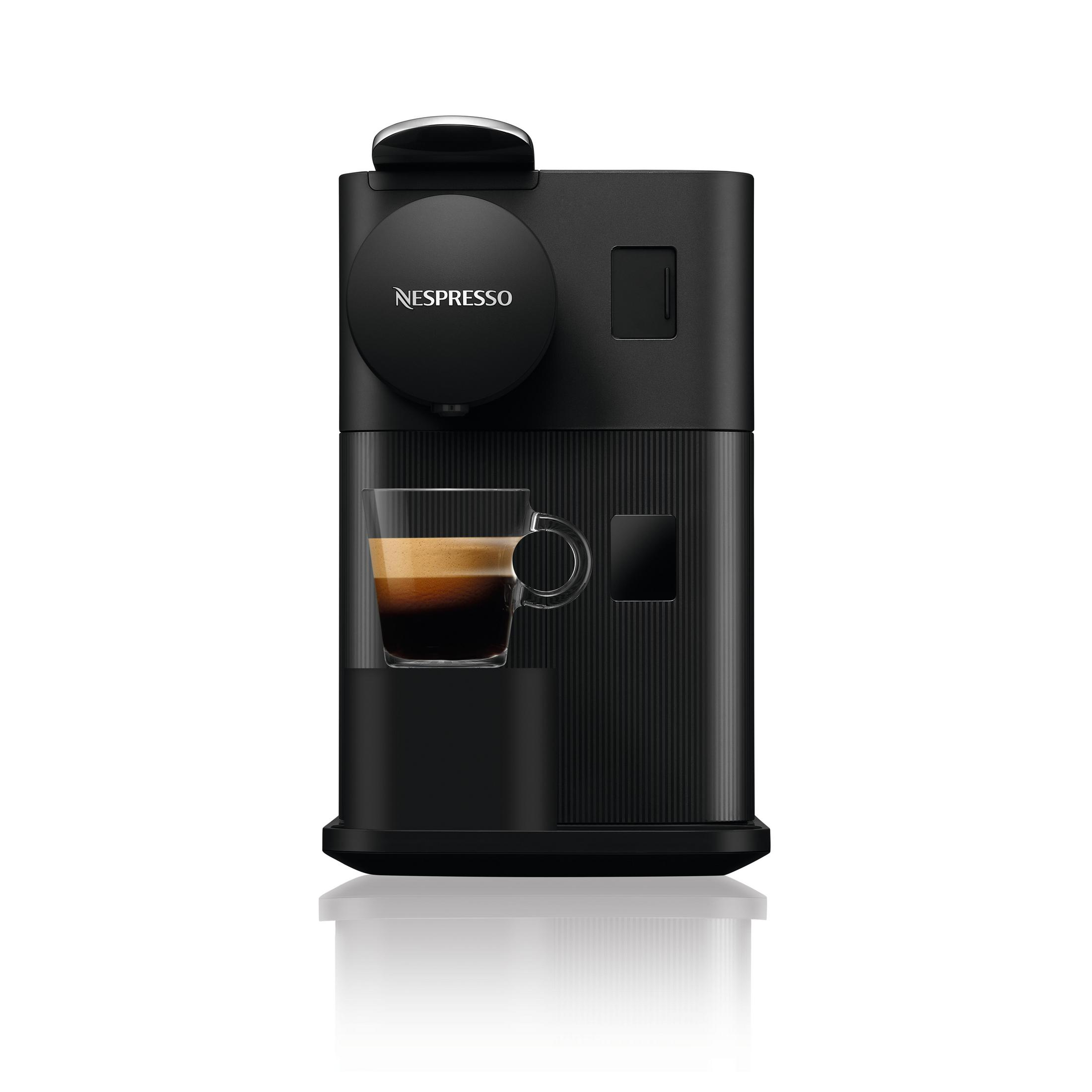 Schwarze Nespresso-Kaffeemaschine mit einem Glas Espresso auf weißer, reflektierender Oberfläche.