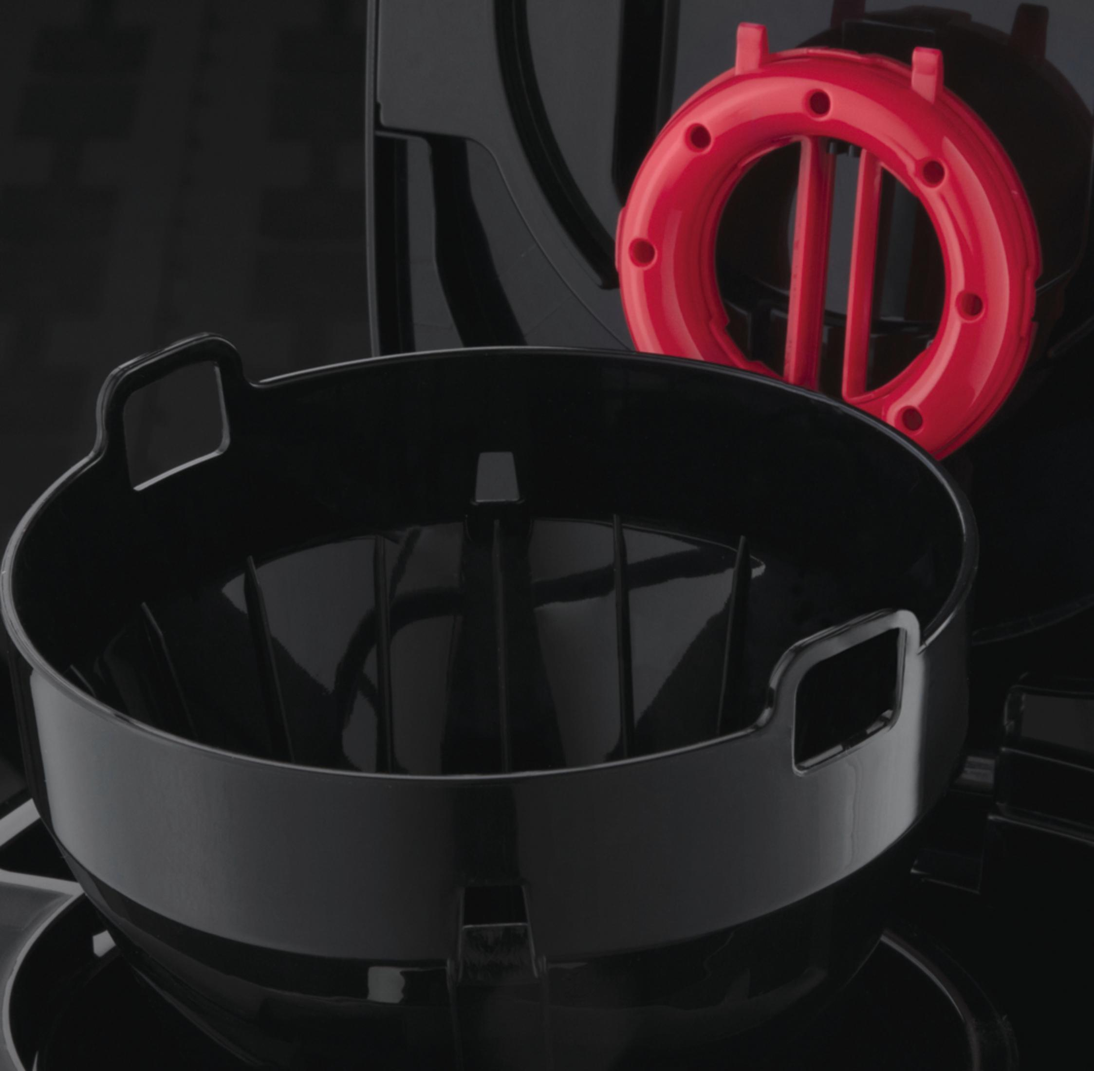 Czarne elementy ekspresu do kawy. Czarna miska, czerwony pierścień i inne czarne części.