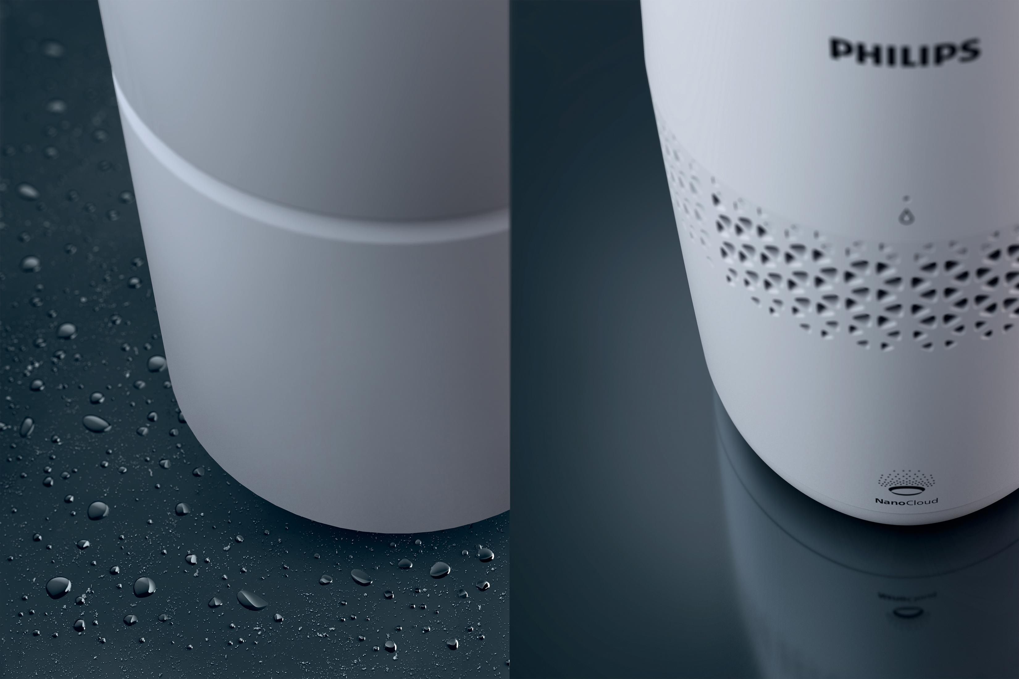 Primer plano de un purificador de aire blanco. Logotipo de la marca Philips. Gotas de agua visibles en la superficie.
