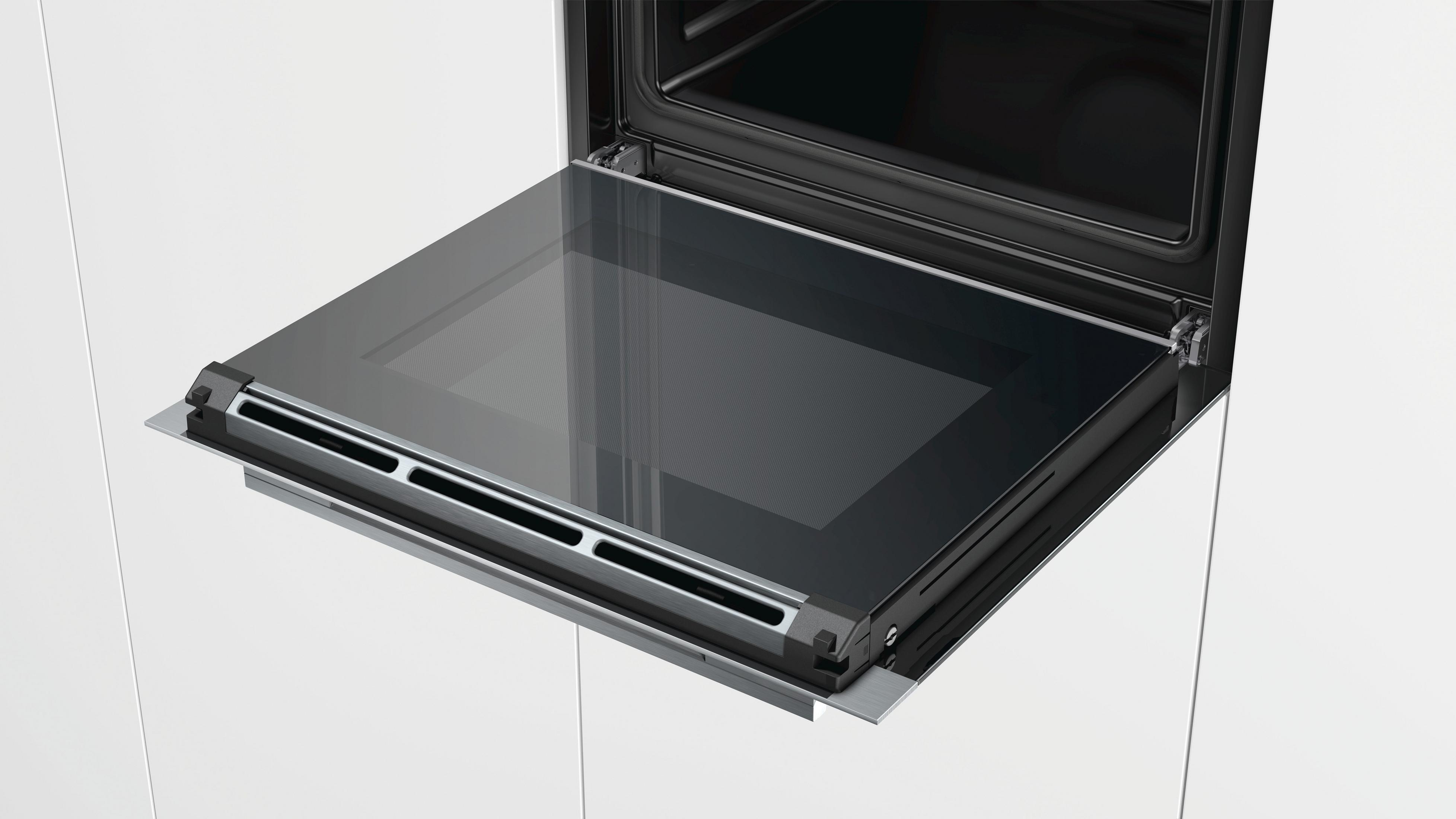 Oven deur open, de binnenkant tonend. De glazen deur is naar buiten uitgeschoven en schuin.