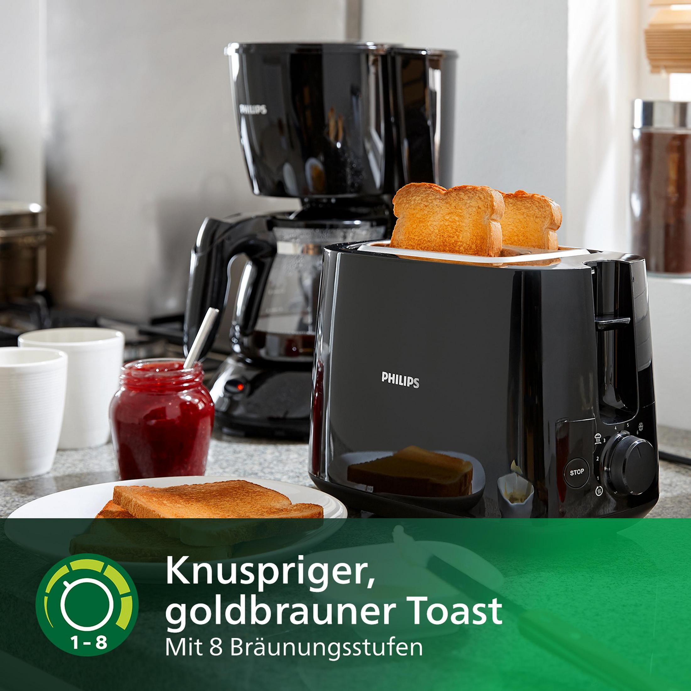 Czarny toster z dwoma kromkami złotego tostu i ekspres do kawy.