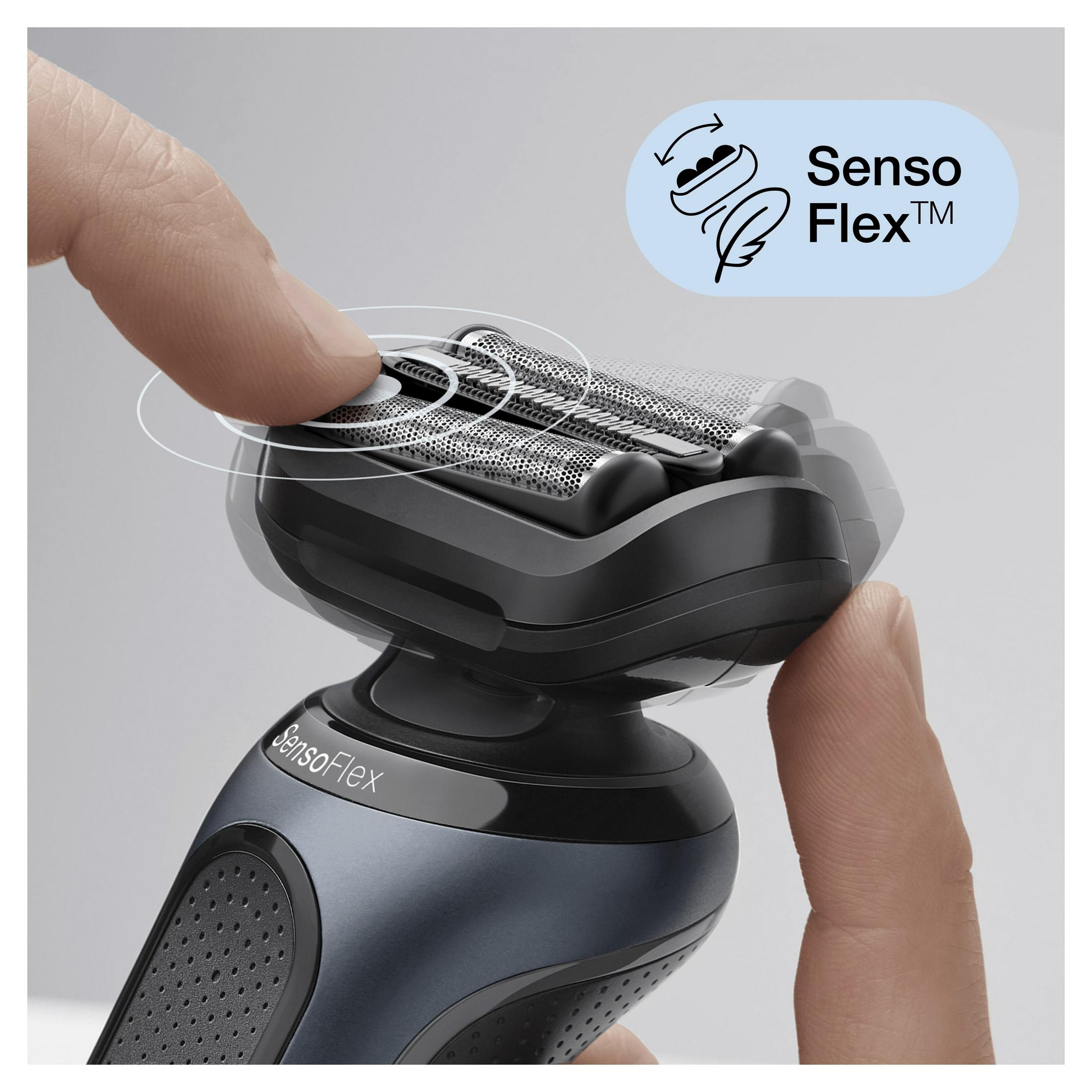 A close-up of a shaver with a hand using the SensoFlex feature. The background is blurry.