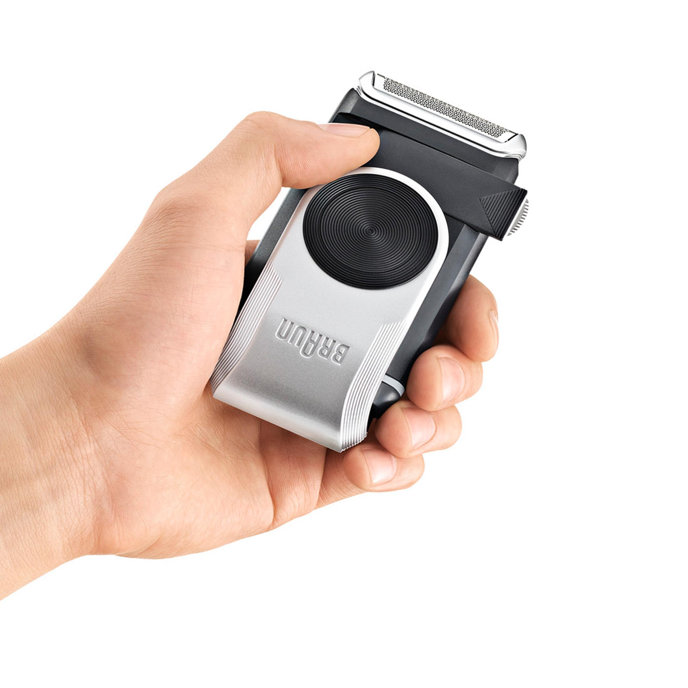 Mano che tiene un rasoio elettrico Braun argento e nero.