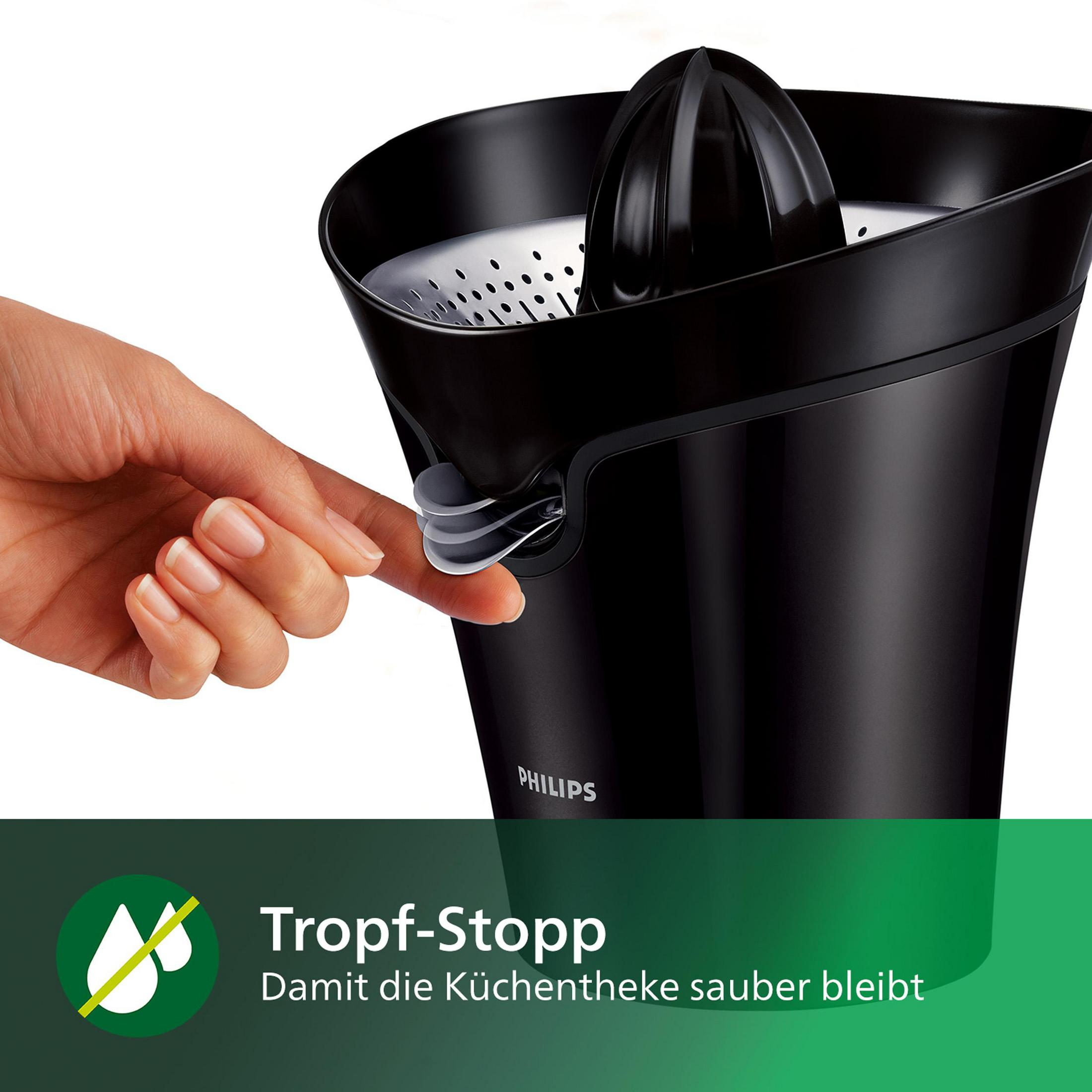 Ein schwarzer Zitrus-Entsafter, mit einer Hand, die einen Hebel drückt, mit einer grünen Grafik.