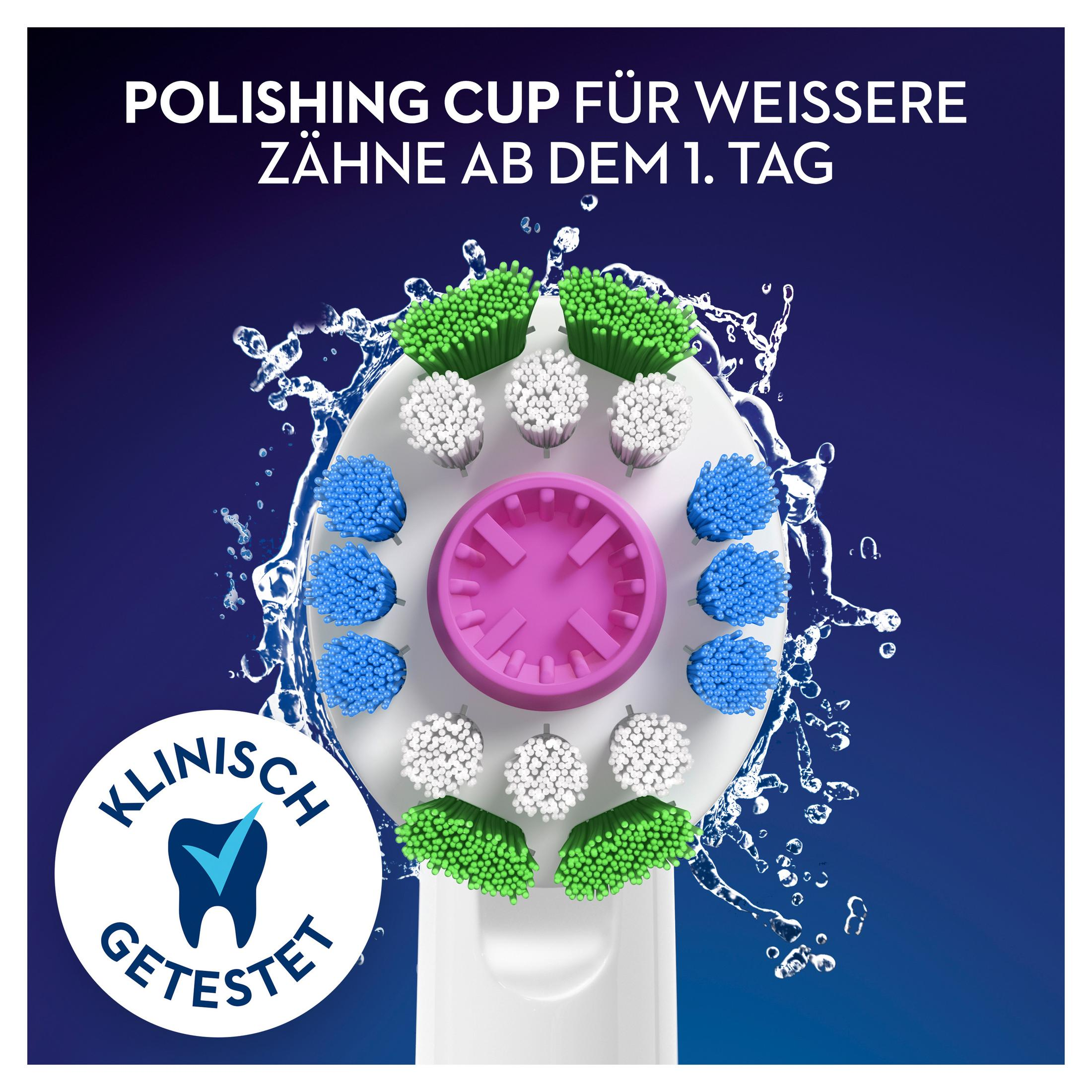 Nahaufnahme eines Zahnbürstenkopfes mit farbigen Borsten und rosa Mitte, umgeben von Wassertropfen auf blauem Hintergrund.