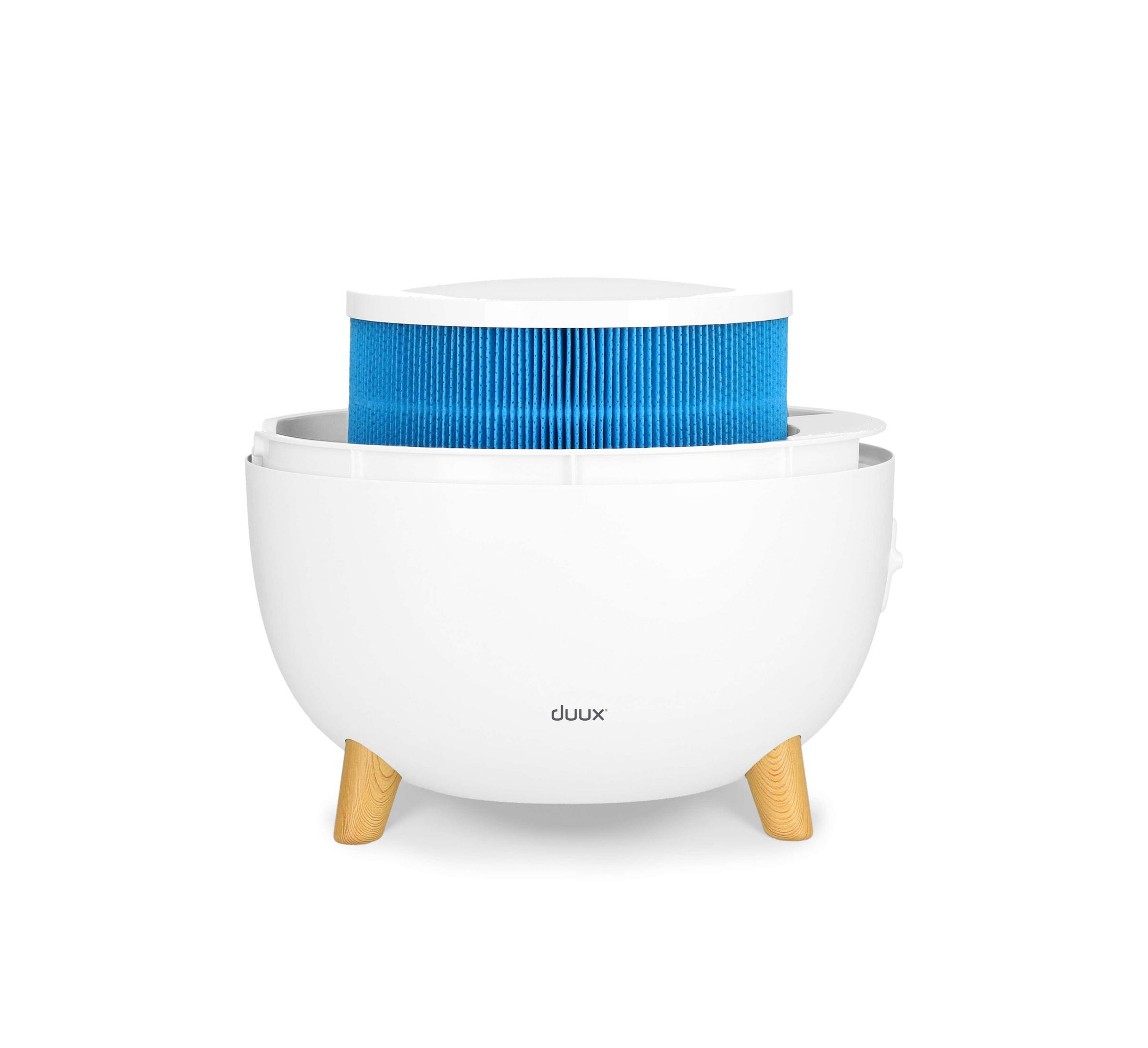White air purifier with blue filter and wooden legs, on white background.