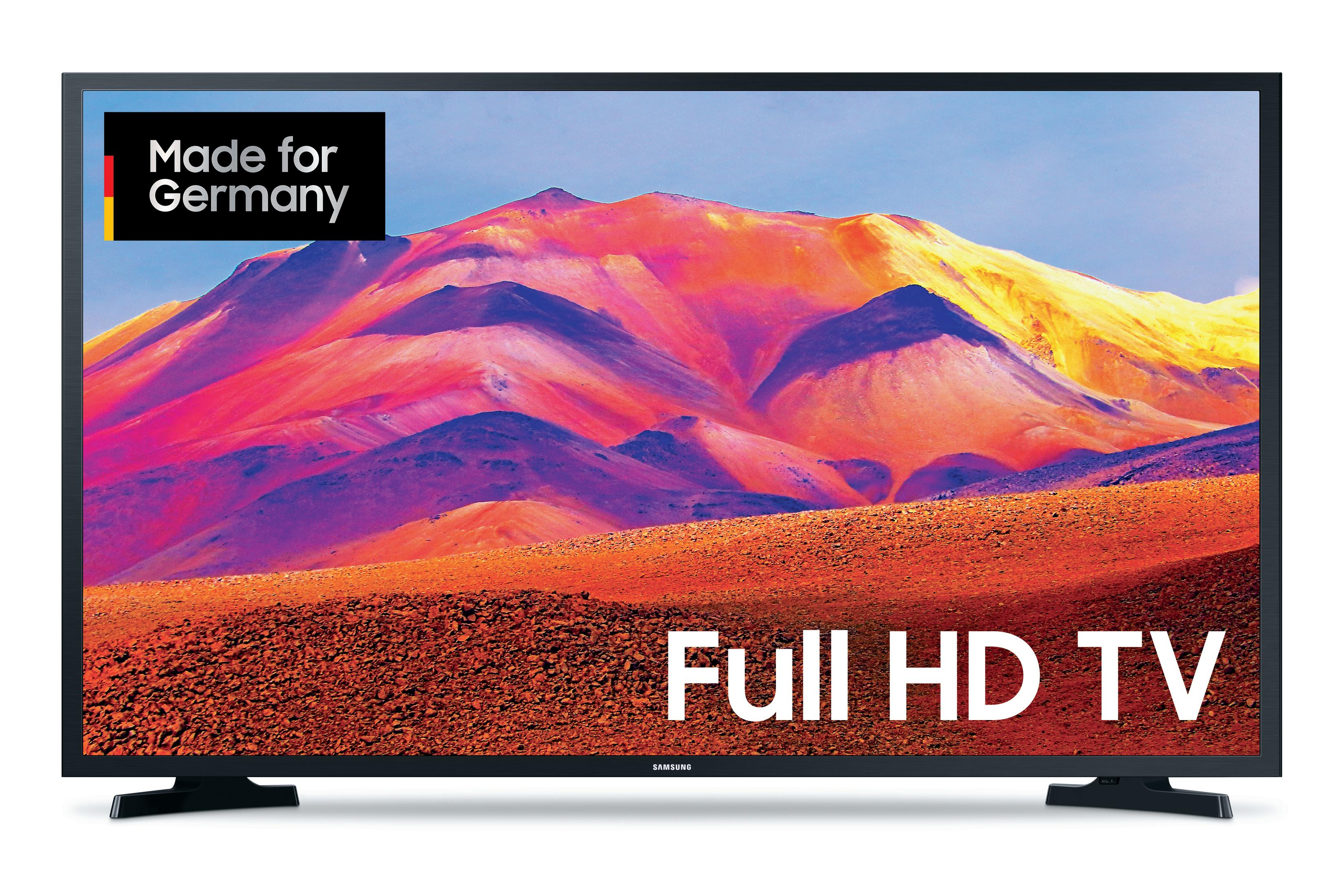 Großer Fernsehbildschirm mit Berglandschaft. Text: Full HD TV. Made in Germany Label.