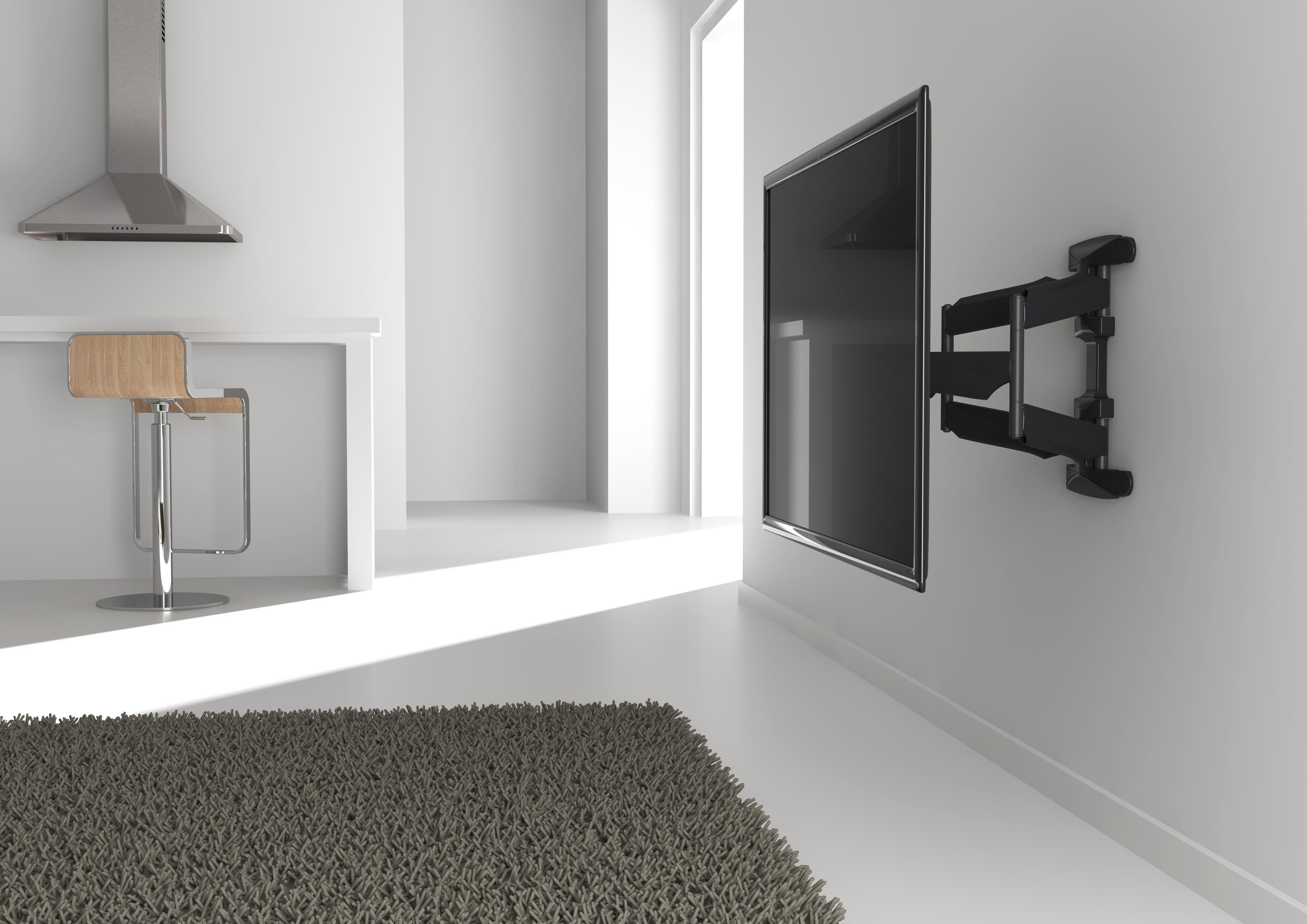 Nowoczesny salon z telewizorem na ścianie, dywanem i drewnianym stołkiem barowym.