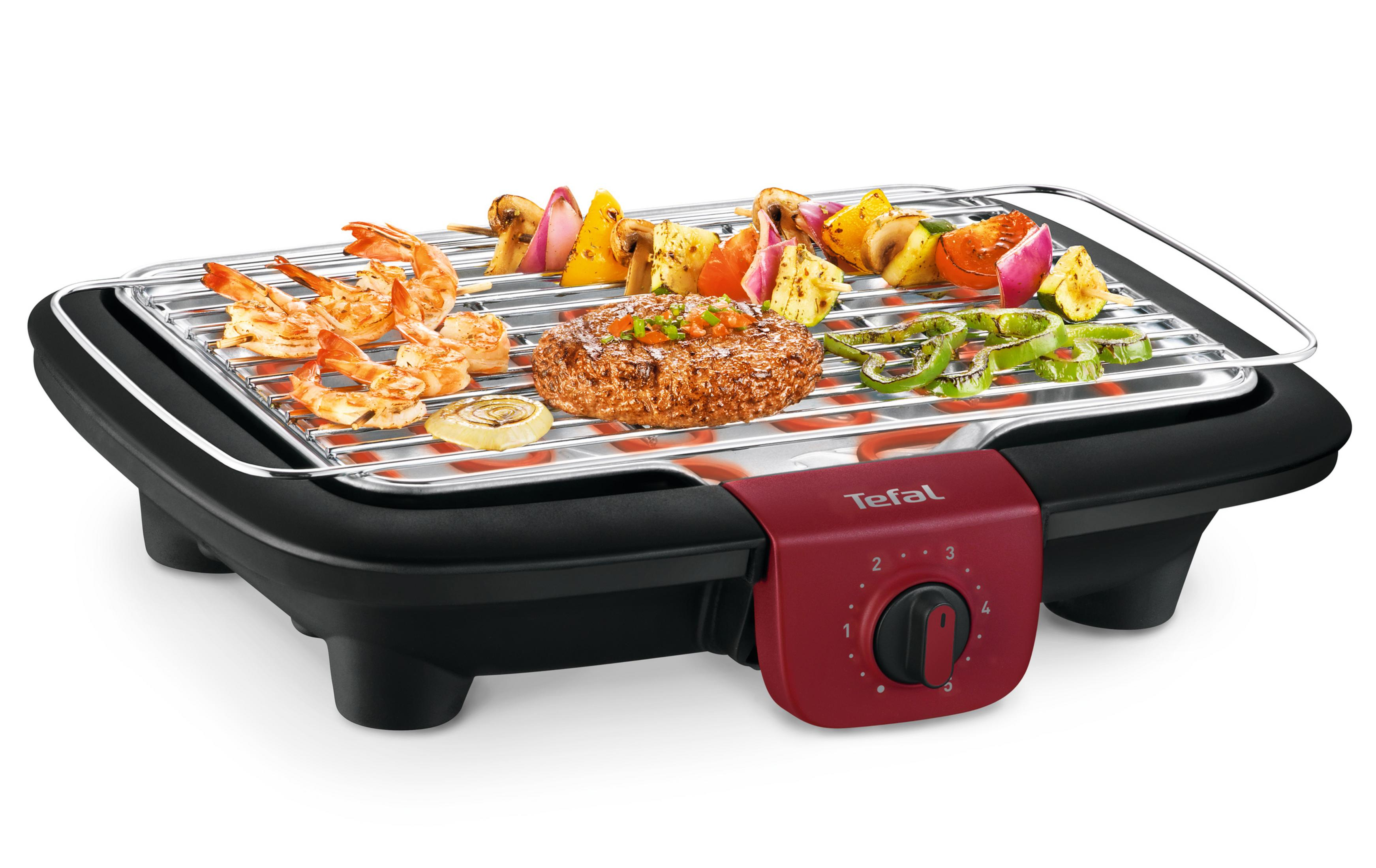 Ein elektrischer Grill mit gekochten Speisen wie Garnelen, Gemüse und einem Burger-Patty.