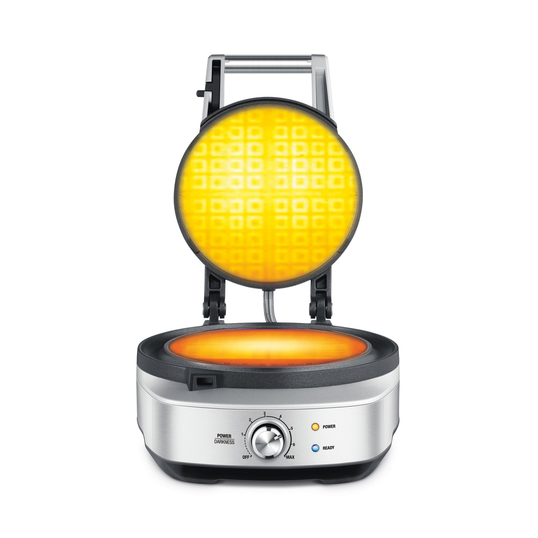 Gofrownica z gofrem w środku. Gofry są podświetlone, a urządzenie jest srebrne.