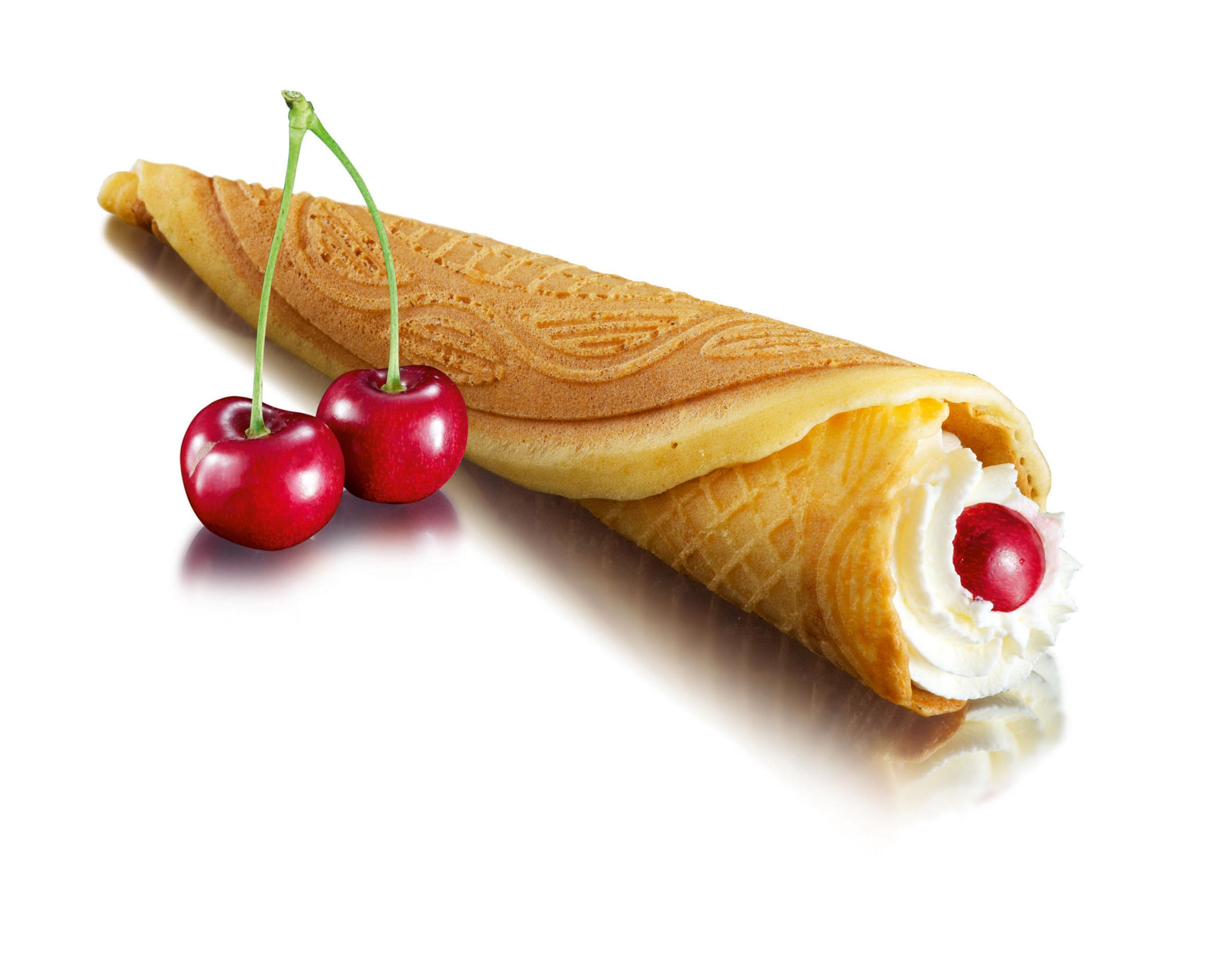 Un cono de gofre relleno de crema batida y una cereza, con dos cerezas.