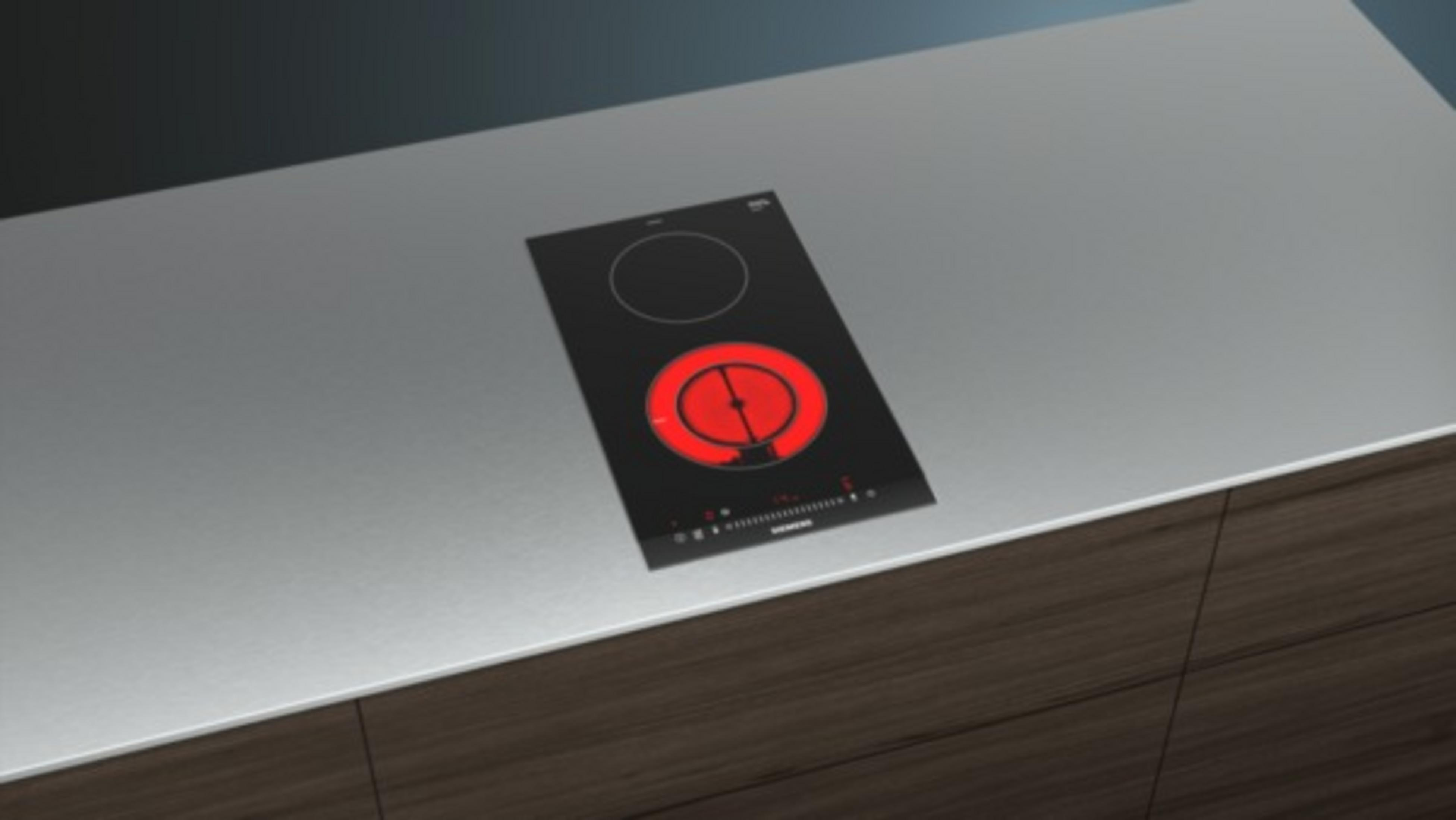 Czarna płyta indukcyjna na szarym blacie z czerwonym gorącym okręgiem.