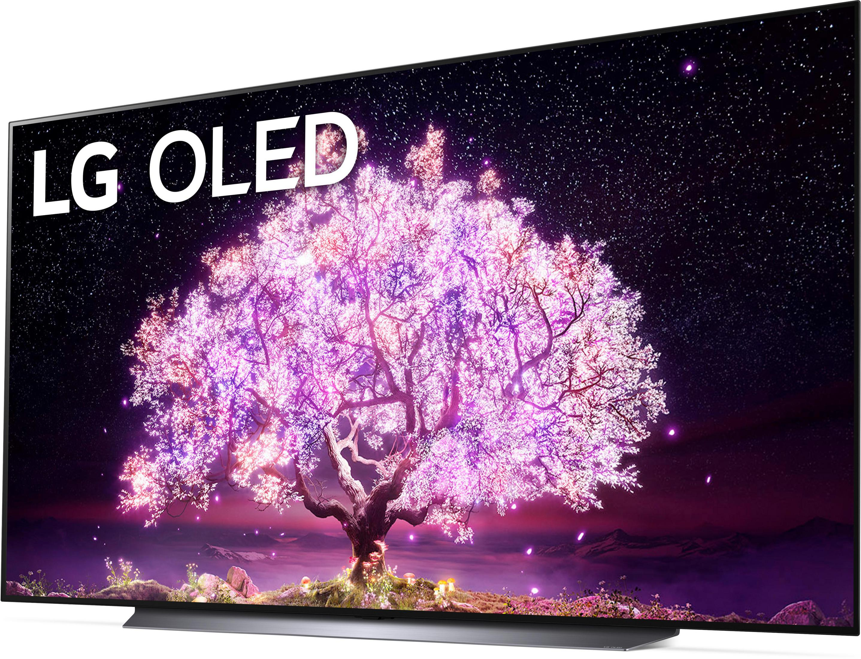 Ein LG OLED-Fernseher zeigt einen pink-lila Baum mit sternenklarem Nachthintergrund.