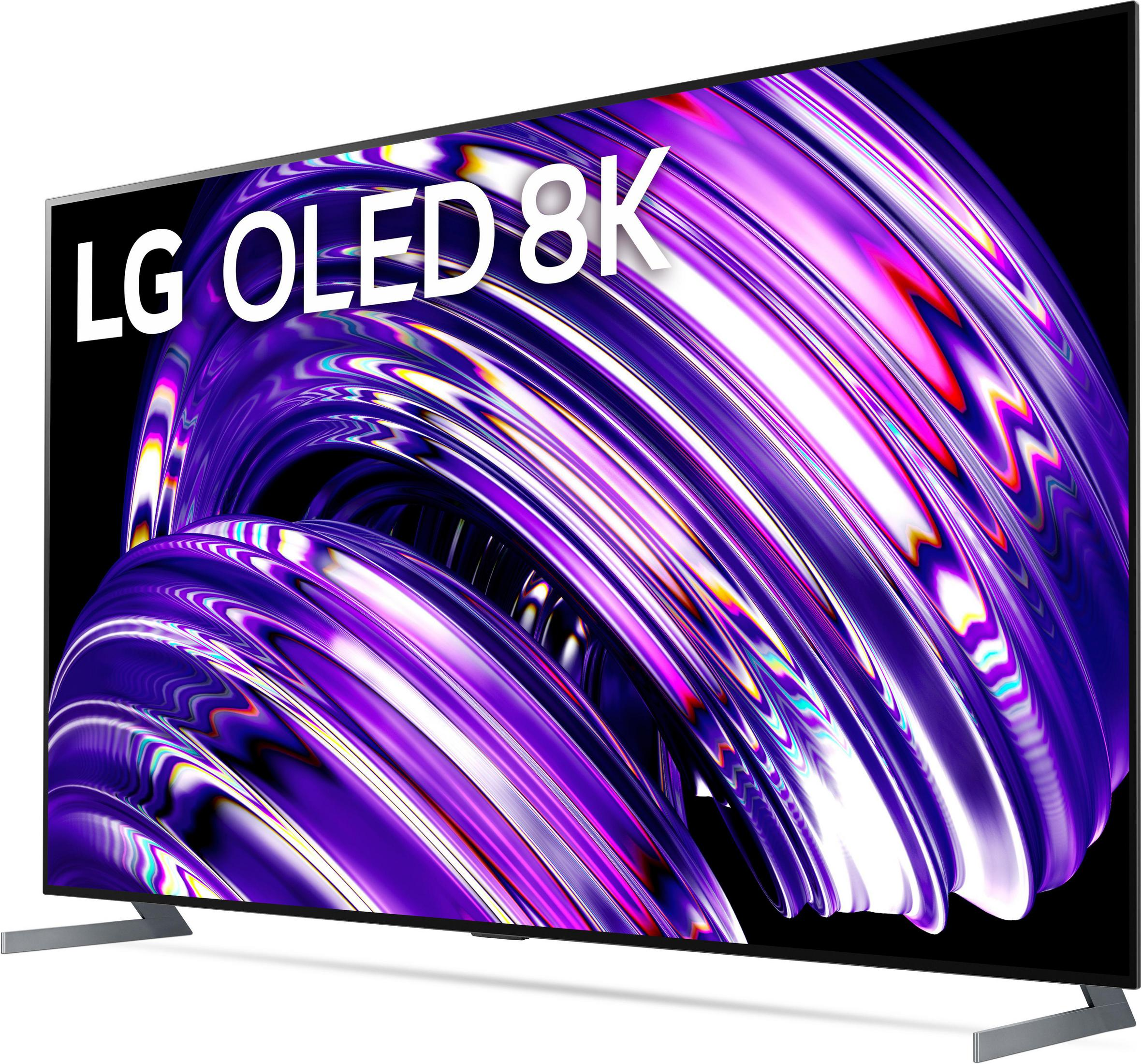 LG OLED 8K TV muestra un diseño abstracto púrpura y blanco. El televisor está en ángulo sobre fondo blanco.