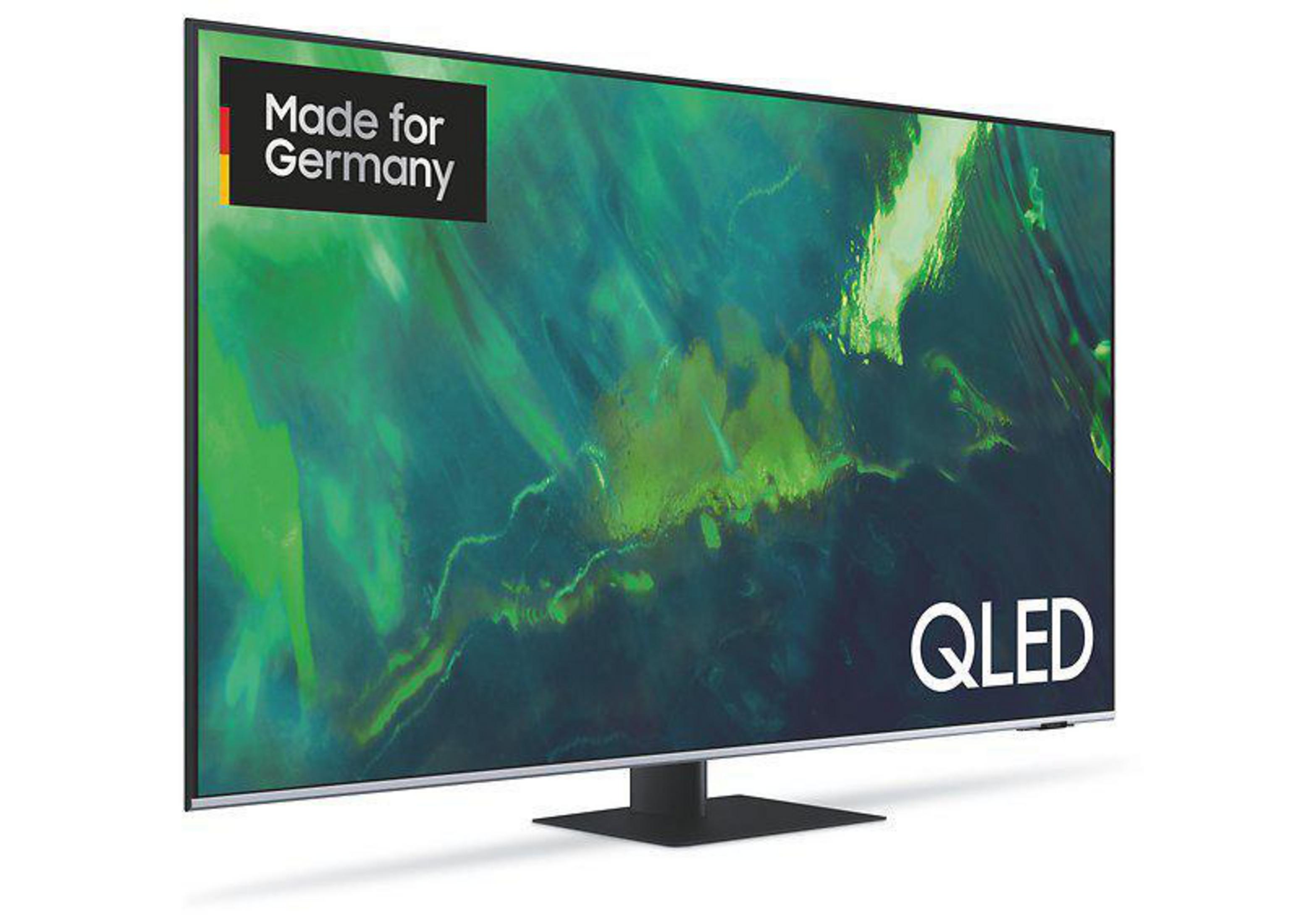 Czarny telewizor QLED z logo 'Made for Germany'. Telewizor stoi na podstawie.