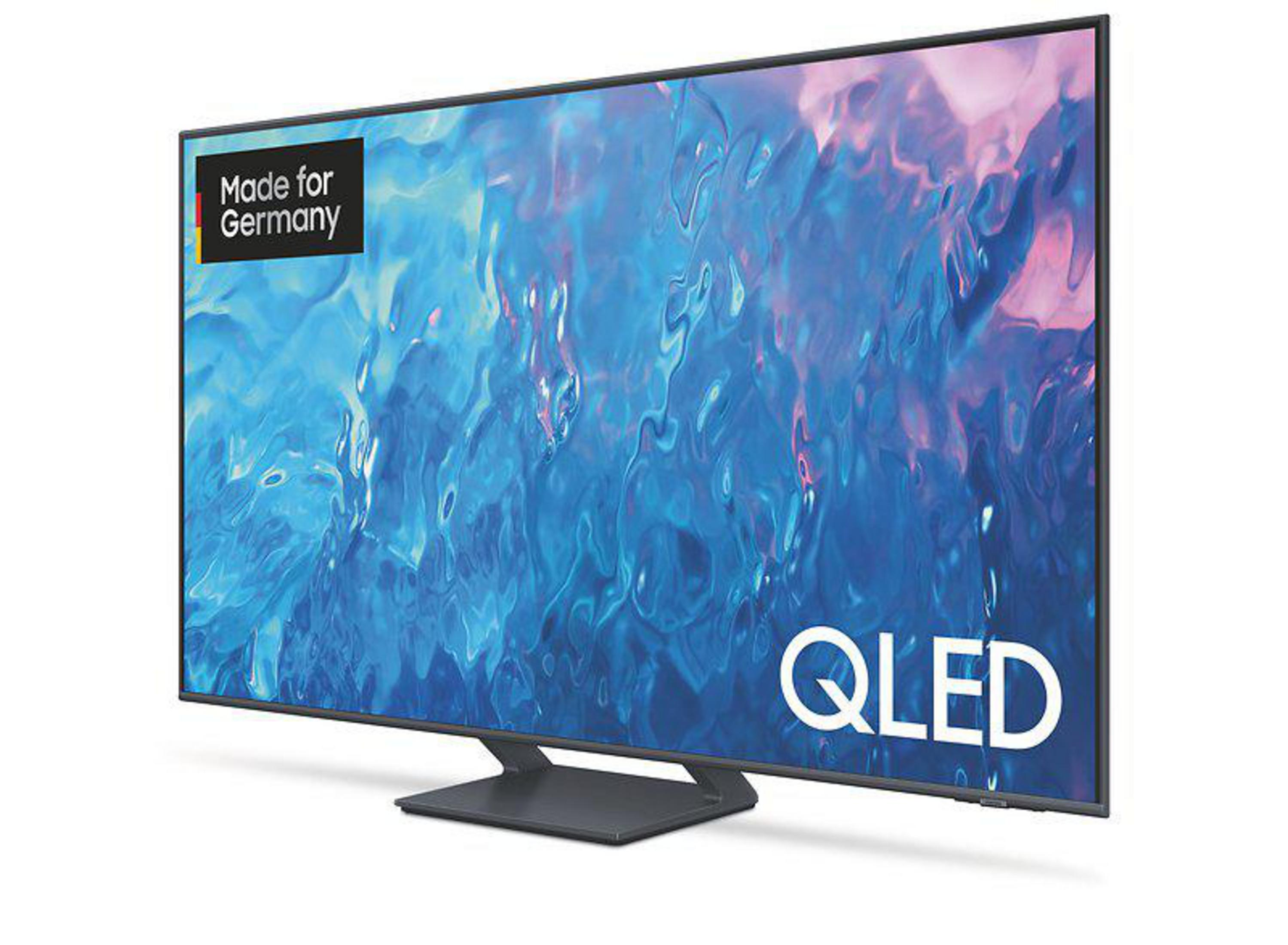 Ein LG OLED-Fernseher mit grünem Baum und Sternenhintergrund.
