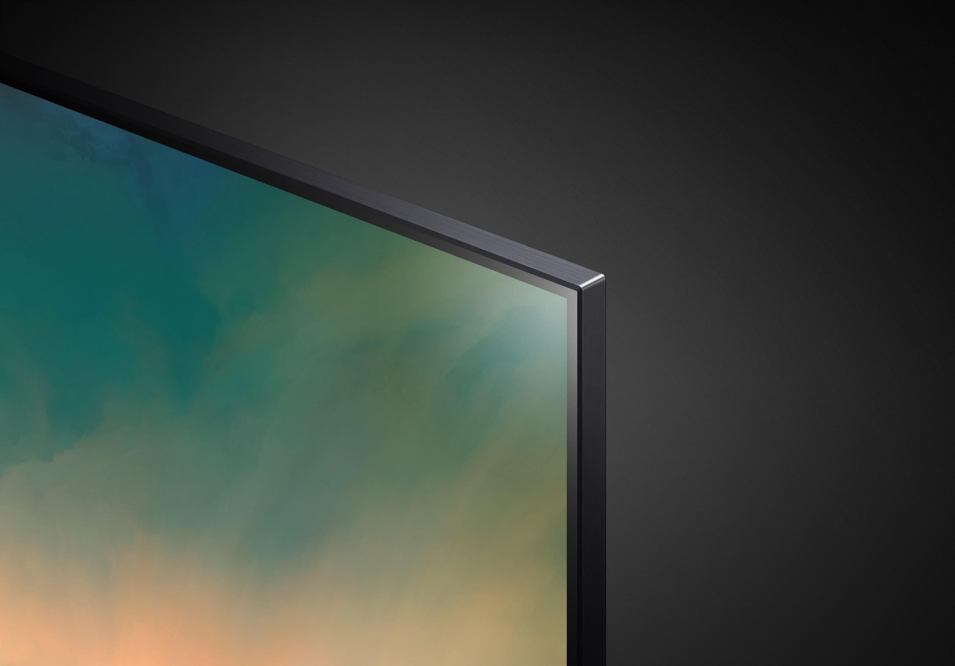 Zbliżenie rogu telewizora. Ekran z gradientem kolorów i czarną ramką.