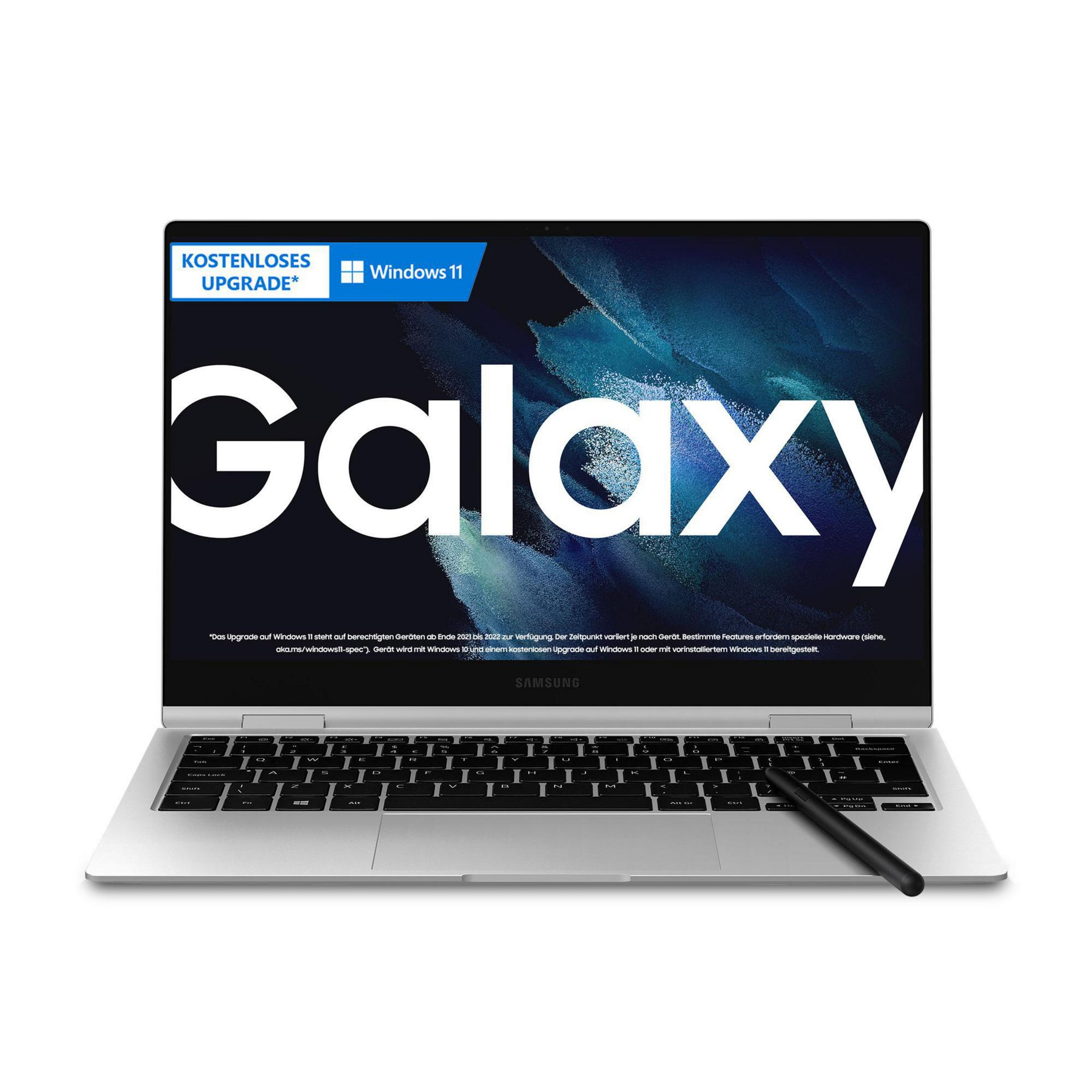 Silberner Laptop mit schwarzer Tastatur und Stift, auf dem Bildschirm das Wort Galaxy anzeigt.