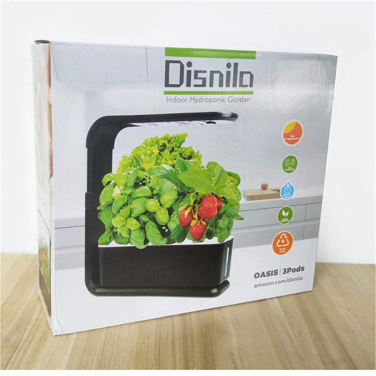 Una caja de kit de jardín hidropónico con un pequeño jardín interior y una variedad de plantas en crecimiento.