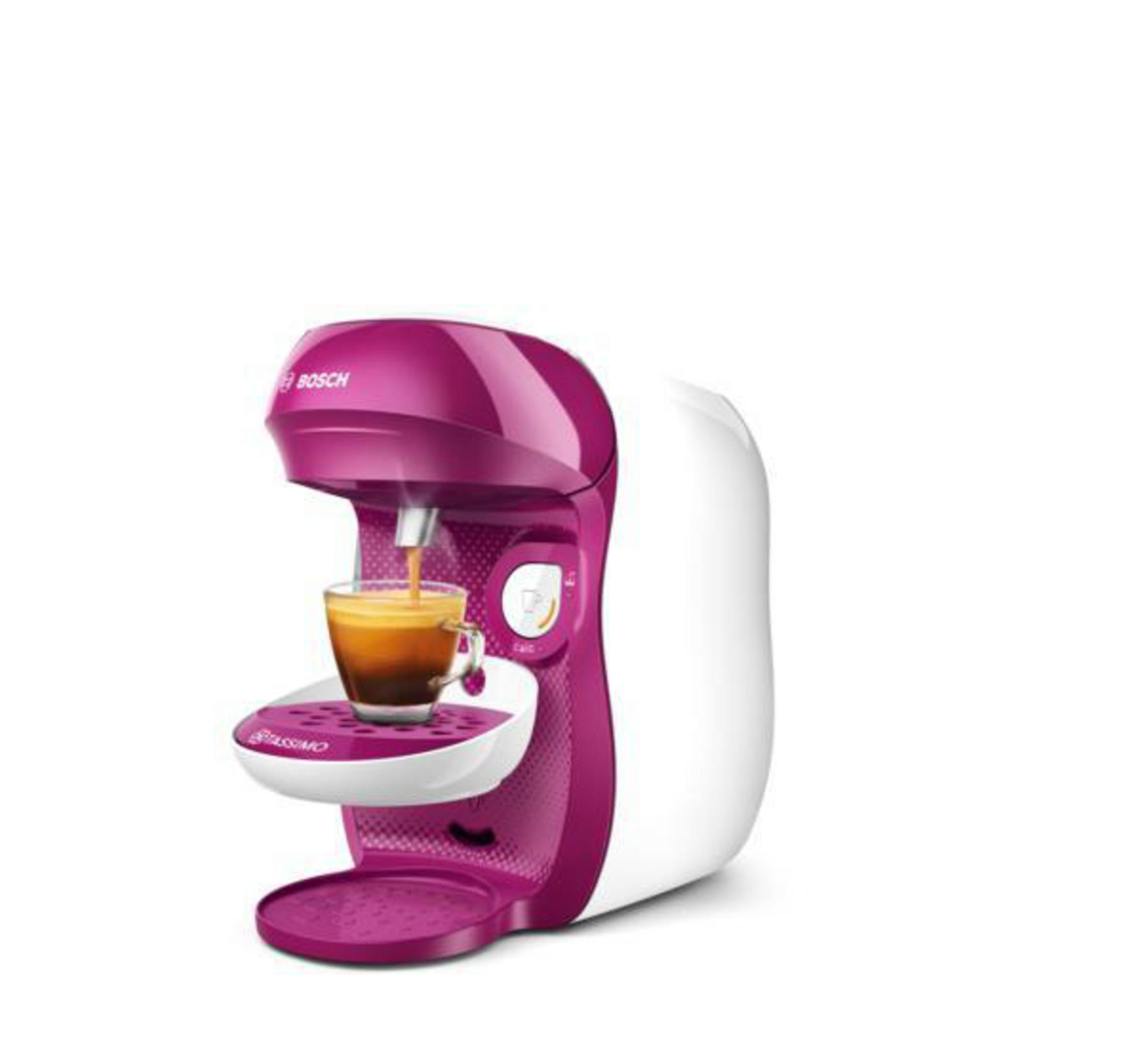 Una macchina da caffè rosa e bianca con un bicchiere di caffè in erogazione.