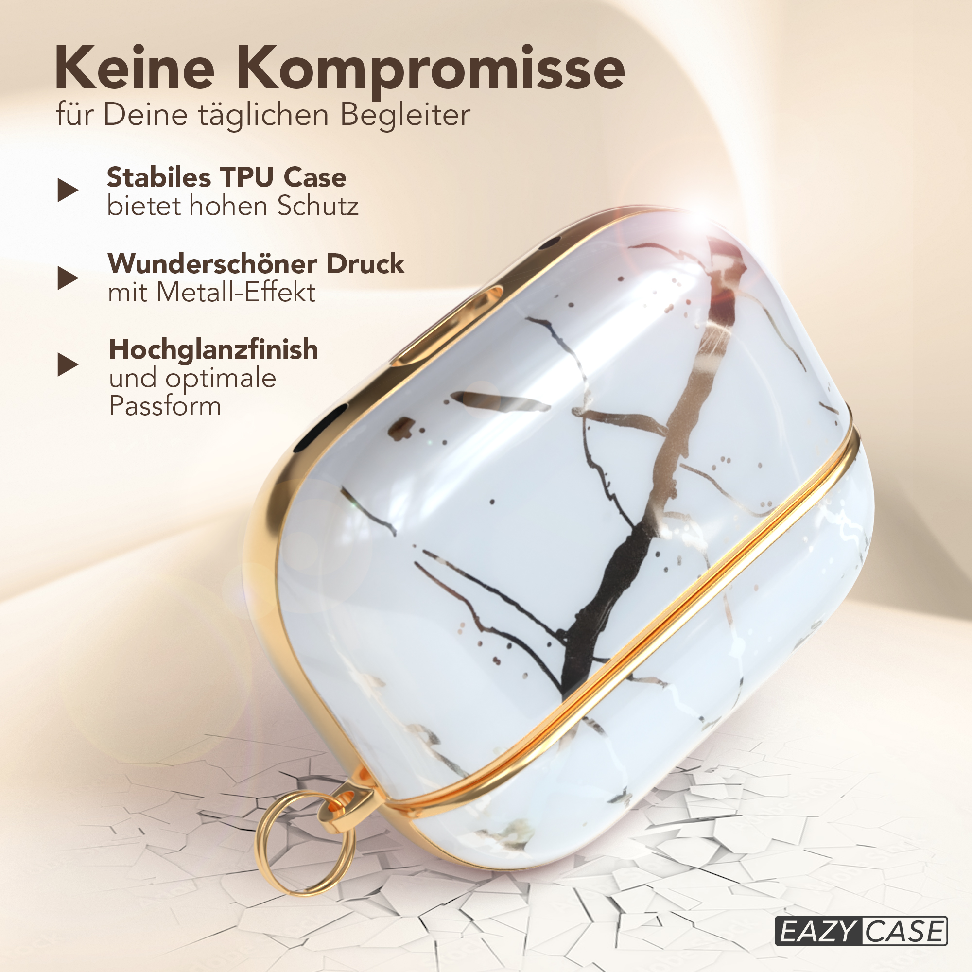 Eine schräge Ansicht einer weißen und goldenen Marmor-AirPods-Hülle, zerbrochene Oberfläche und Ring.
