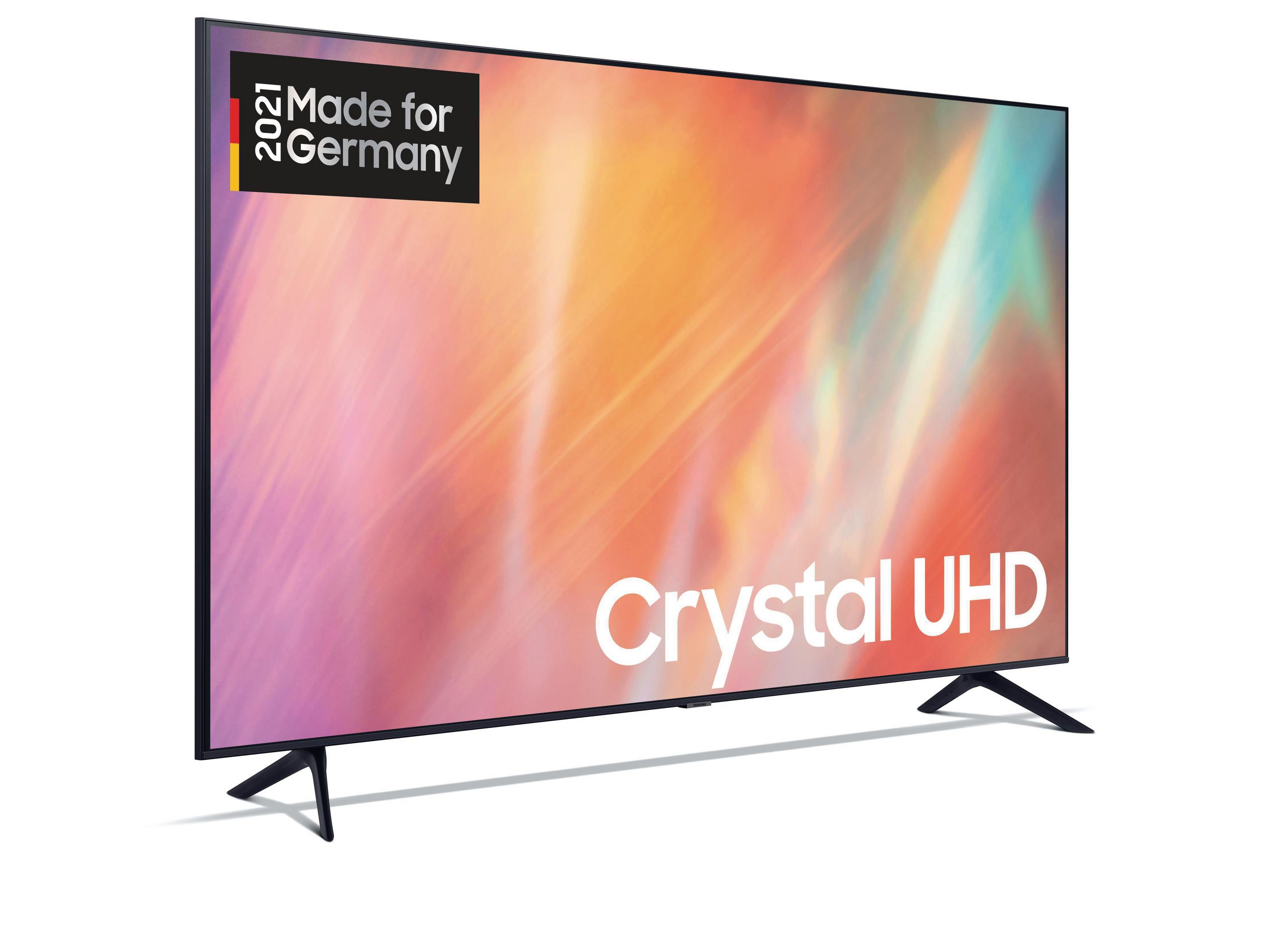 Duży telewizor Samsung z tekstem 'Crystal UHD' na ekranie. Białe tło.