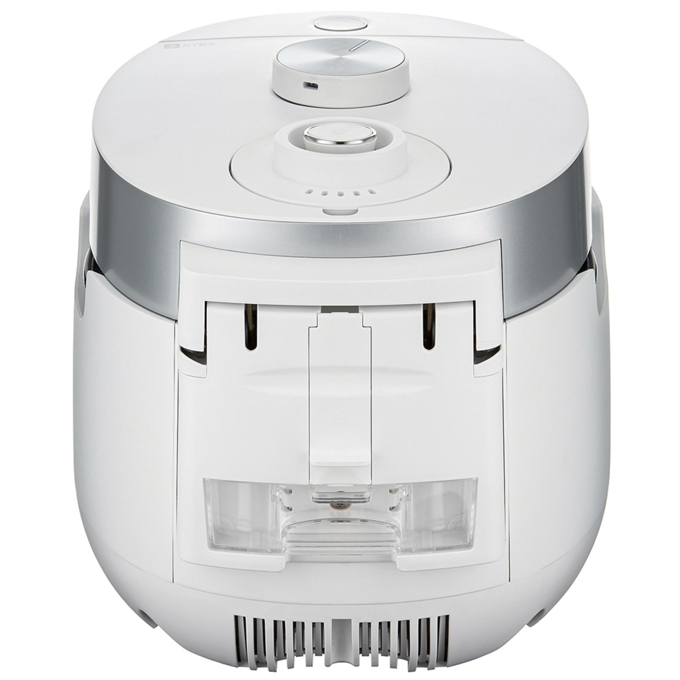 Biały garnek do ryżu z okrągłym blatem, srebrnymi akcentami i otworem z przodu na wodę.