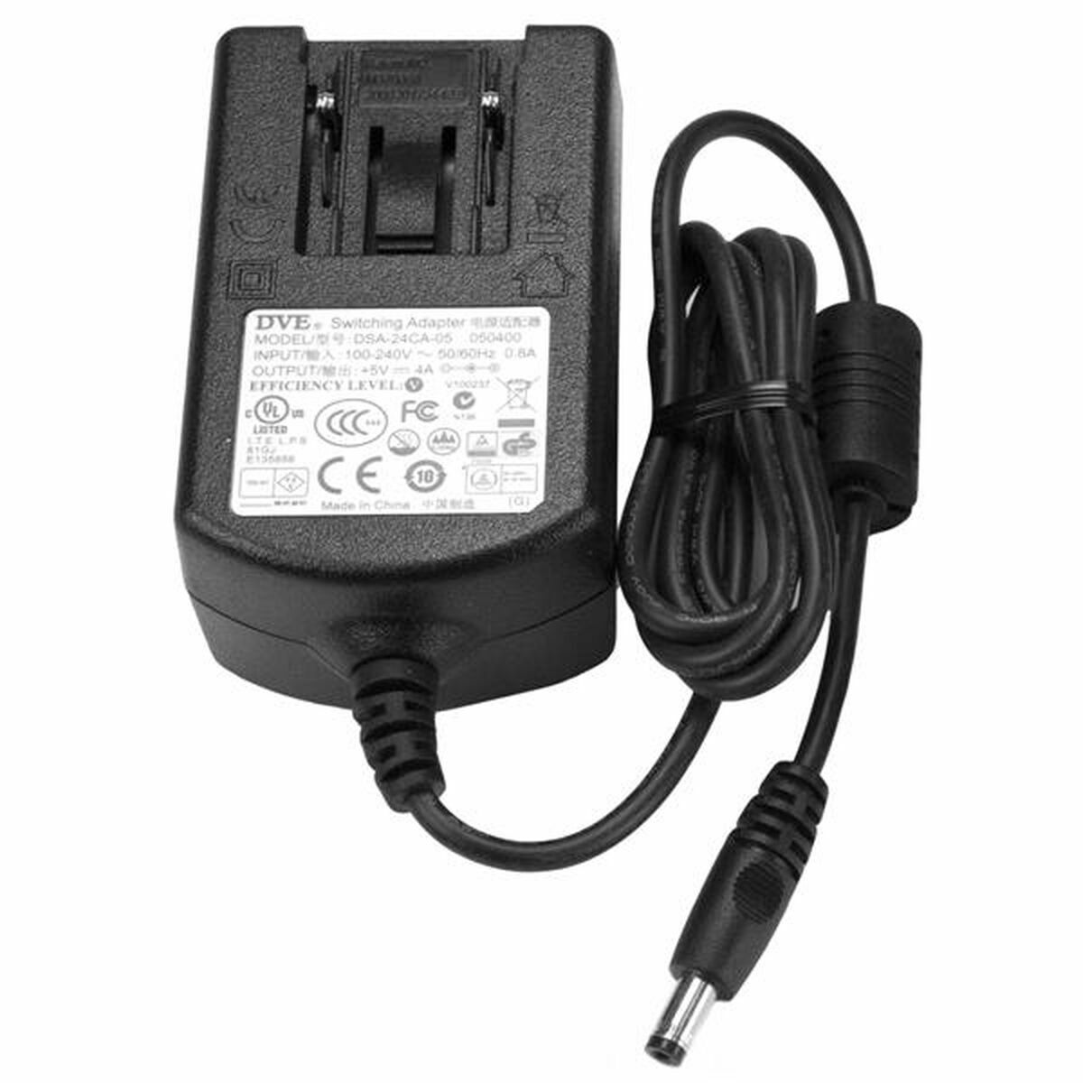 Adaptador de corriente negro con múltiples símbolos regulatorios.