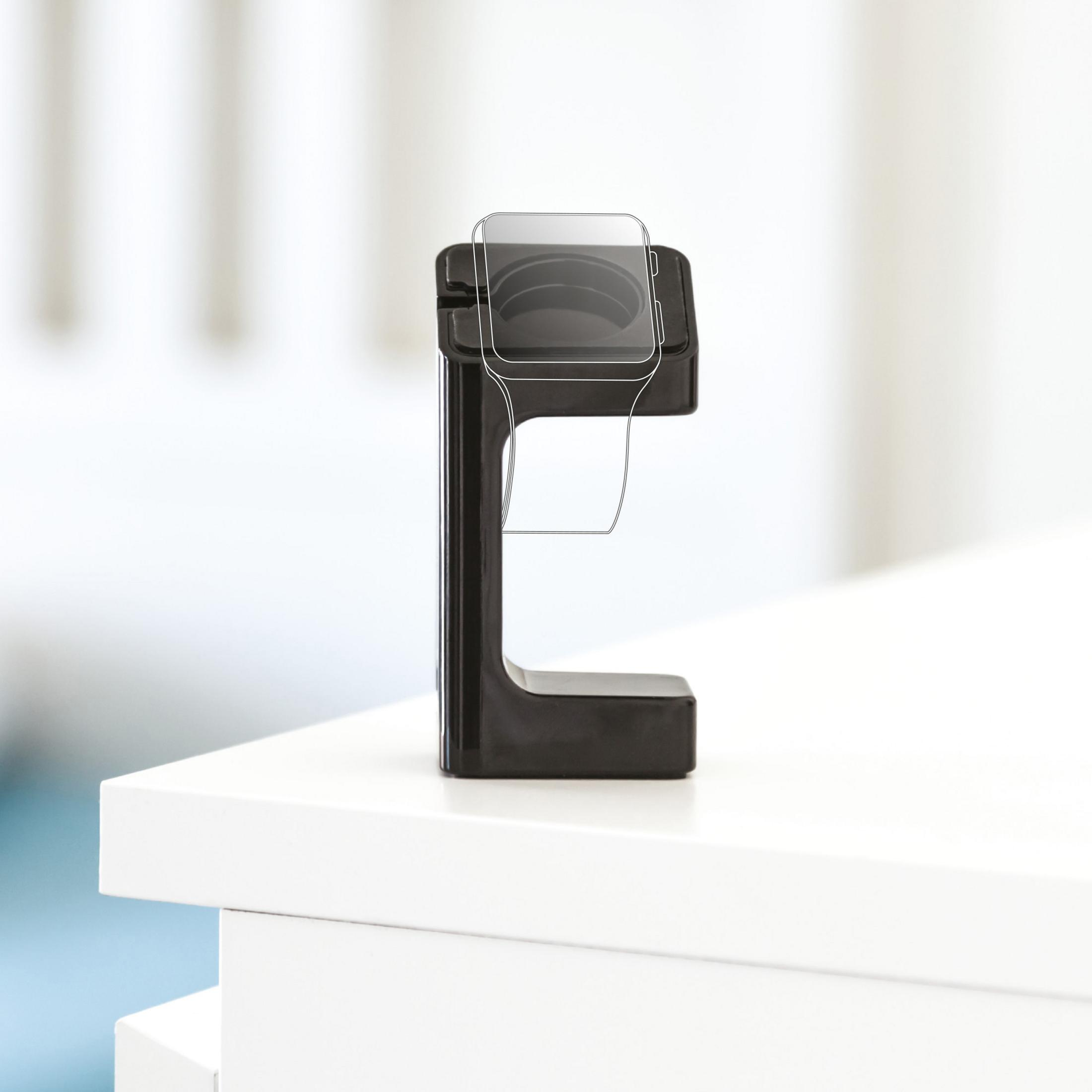 Eine schwarze Ladestation für eine Smartwatch steht auf einer weißen Oberfläche. Die Uhr ist umrissen.