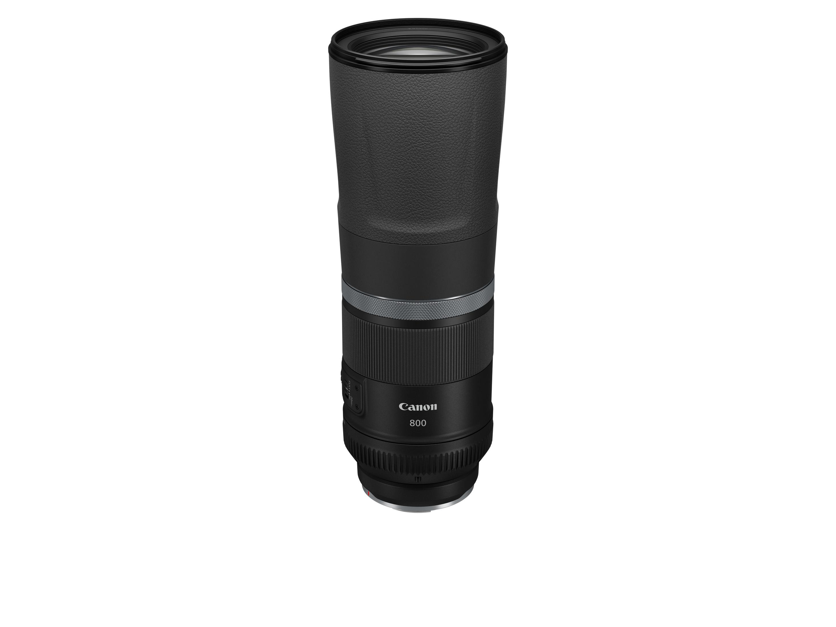 Black Canon 800mm lens, long and cylindrical, on a white background, with various markings and a lens hood.