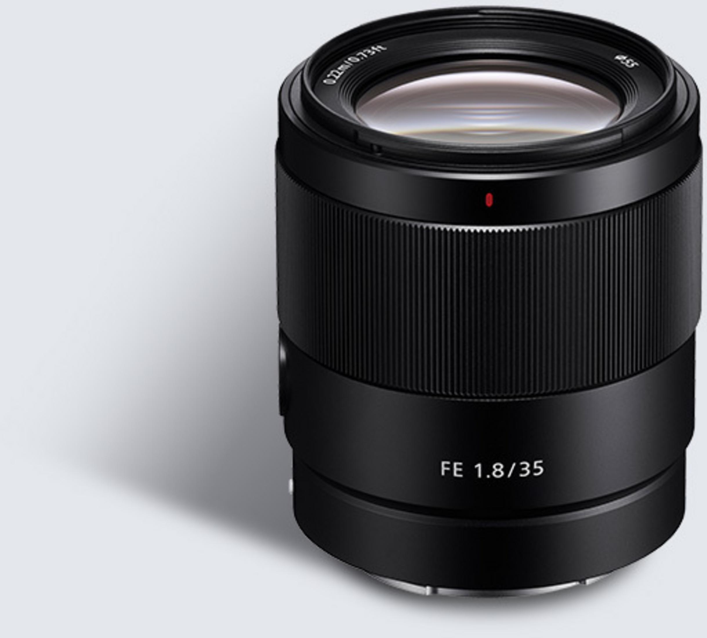 Black camera lens with red dot.