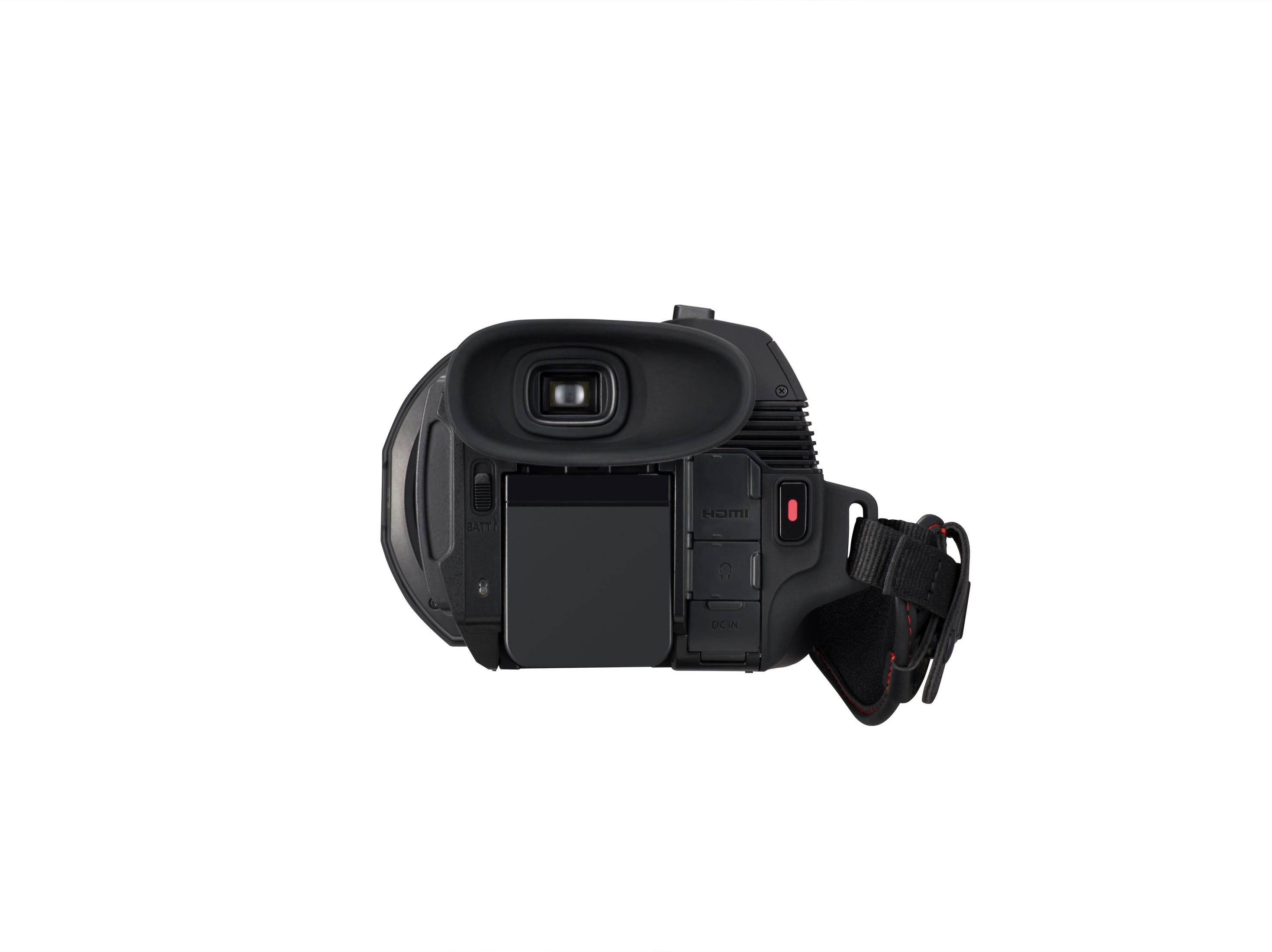 Videocamera nera dall'alto. Lo schermo e i comandi sono visibili. Sfondo bianco.