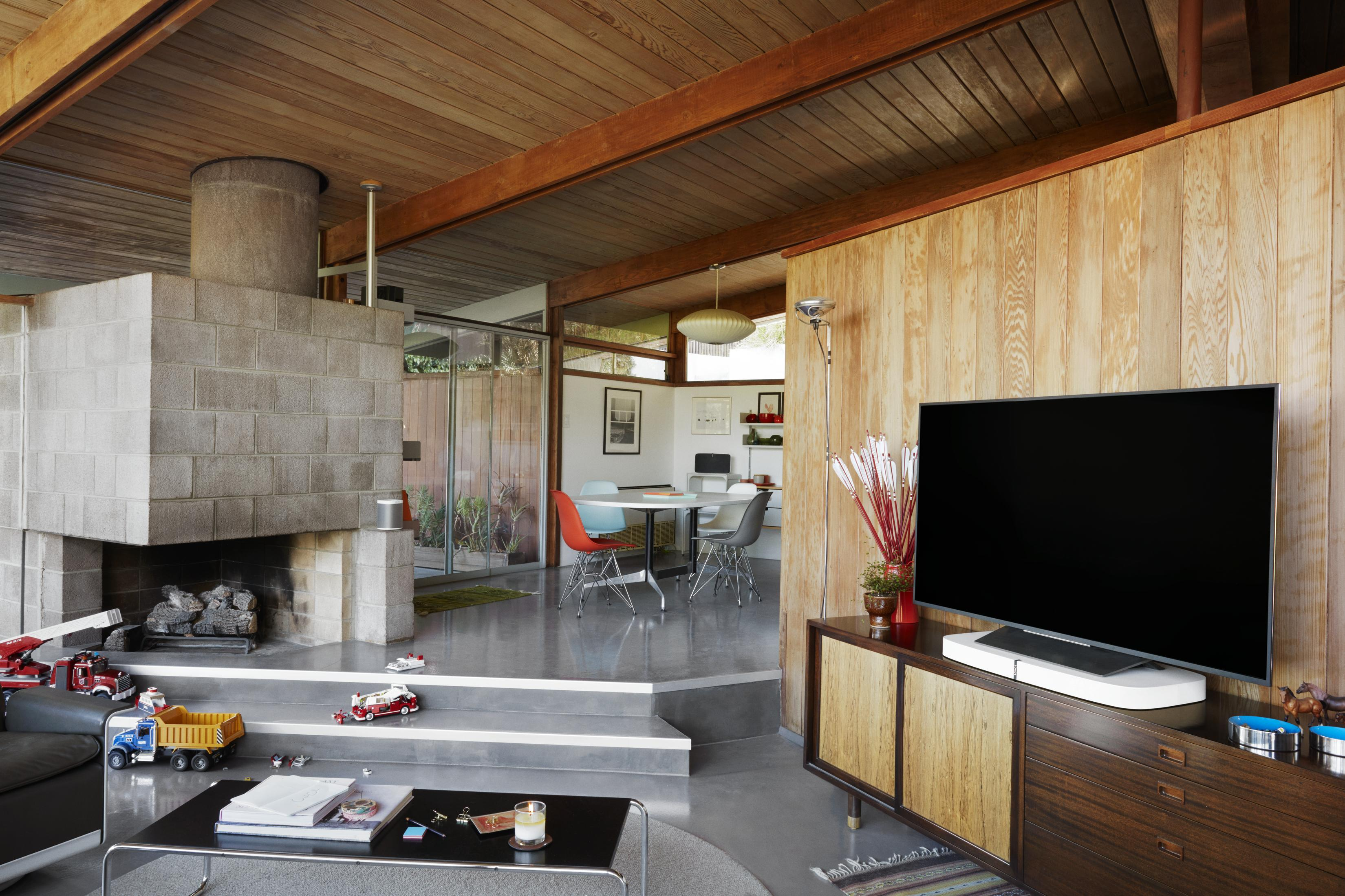 Living room with fireplace, TV, and toys.