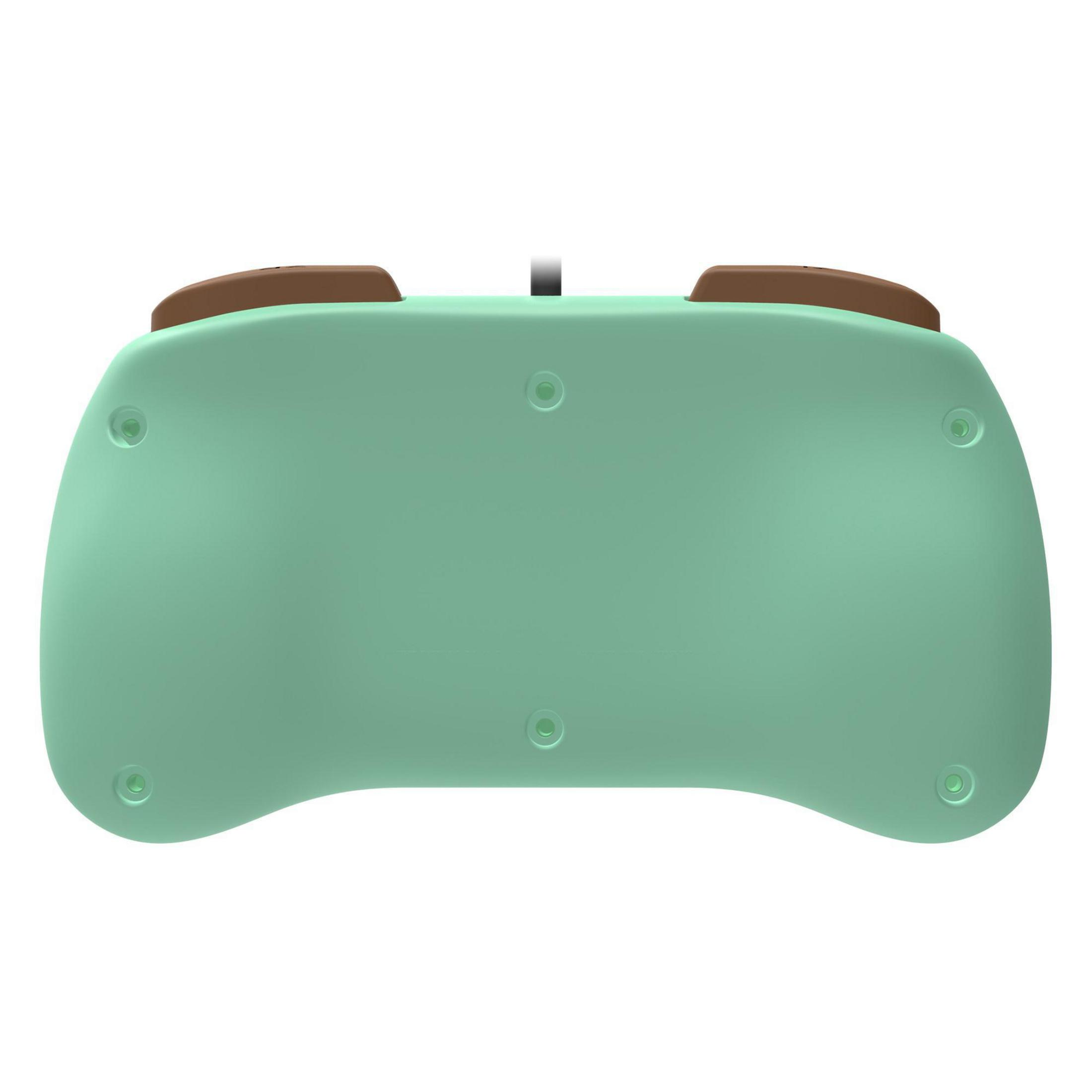 Spód miętowo-zielonego kontrolera z brązowymi nakładkami. Tło jest białe.