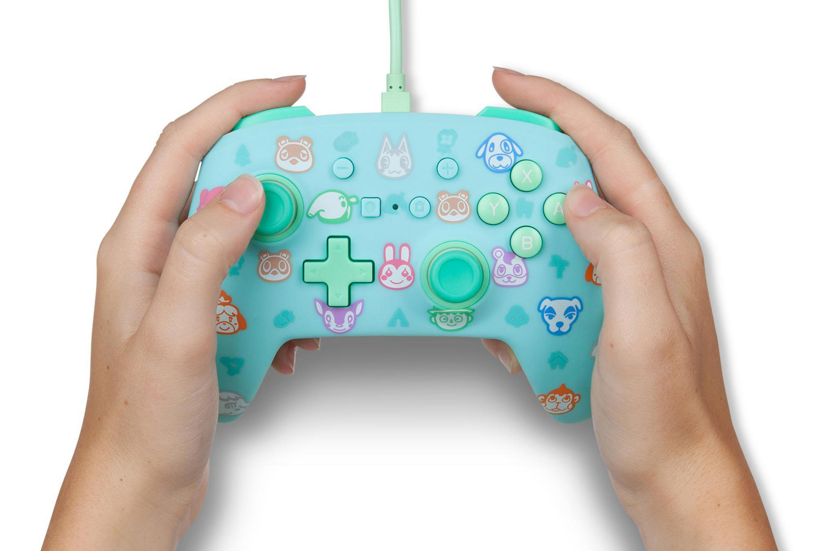 Kontroler Animal Crossing Switch. Turkusowy, z ikonami postaci.
