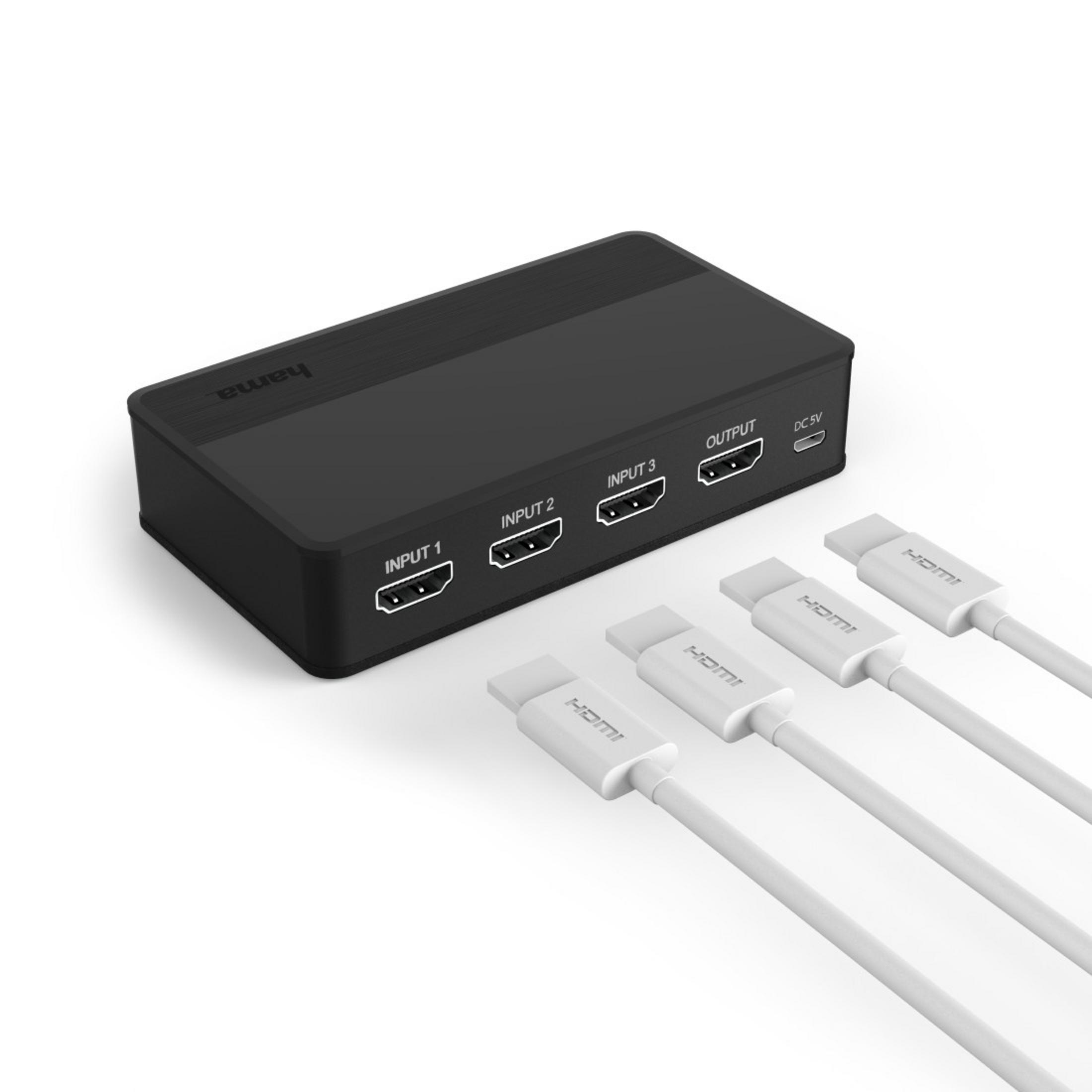 Switch HDMI negro con cables HDMI enchufados.