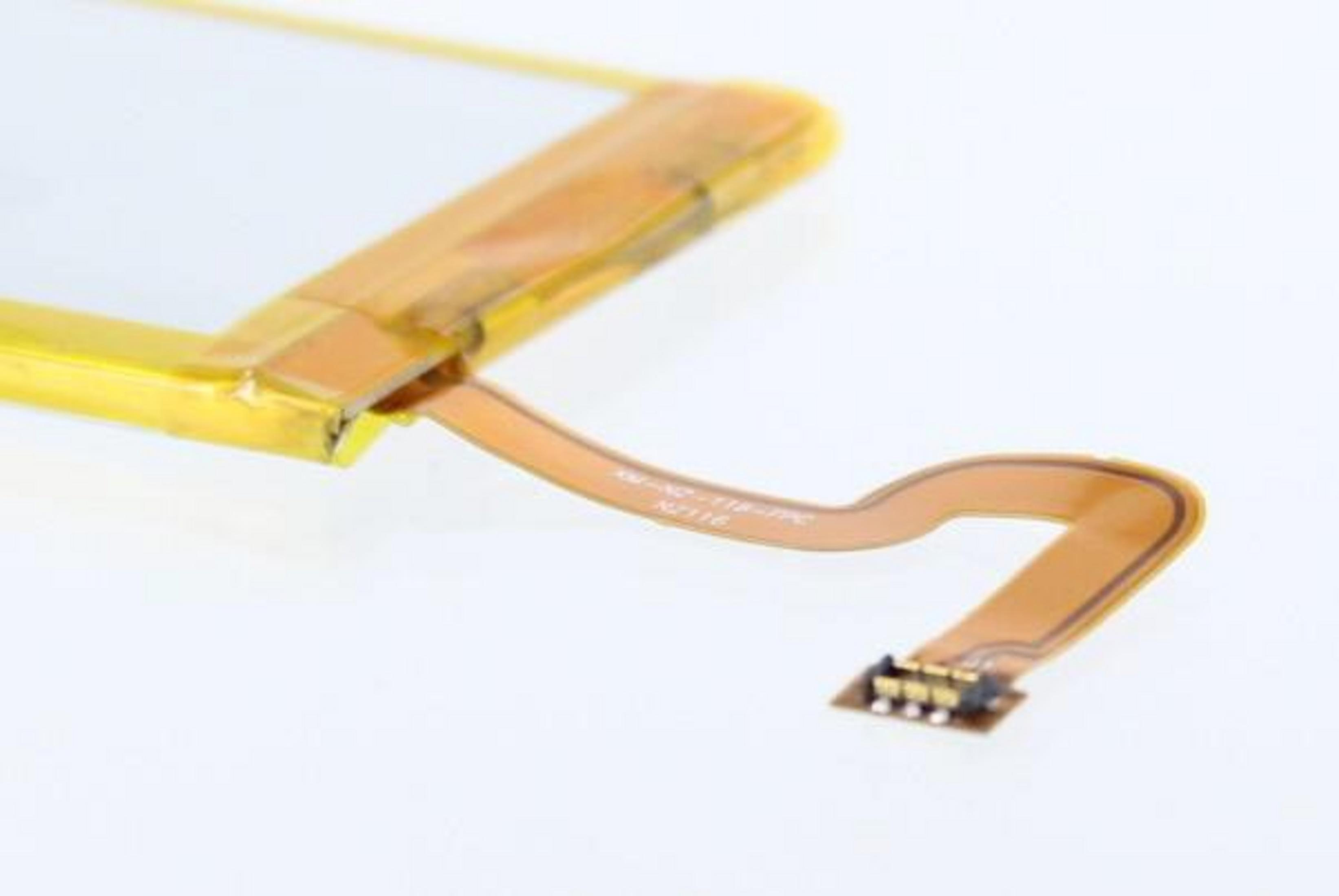Eine gelb-braune elektronische Komponente mit einem Kabel, das sich nach rechts erstreckt.