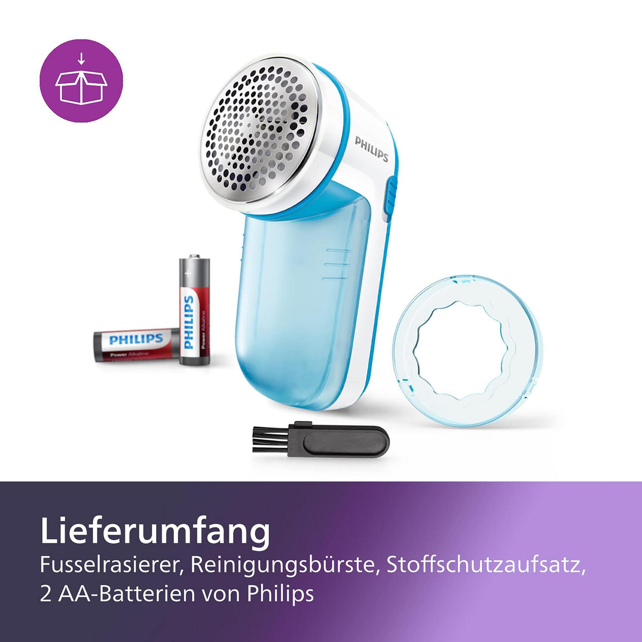 Ein Philips Stoffrasierer mit Zubehör und zwei Philips Batterien. Weißer Hintergrund.