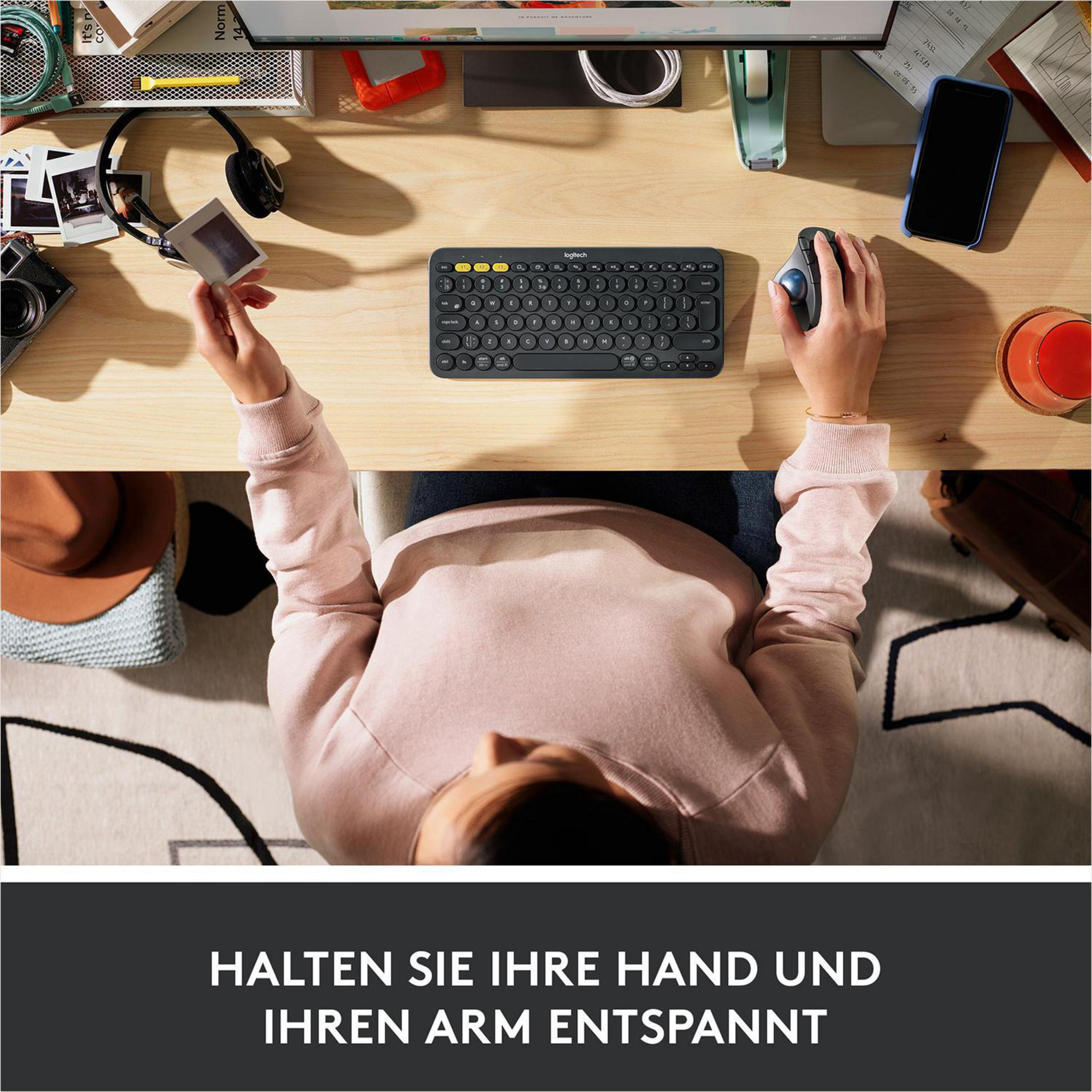 Kobieta używająca czarnej klawiatury i myszy na biurku, z tekstem na dole.