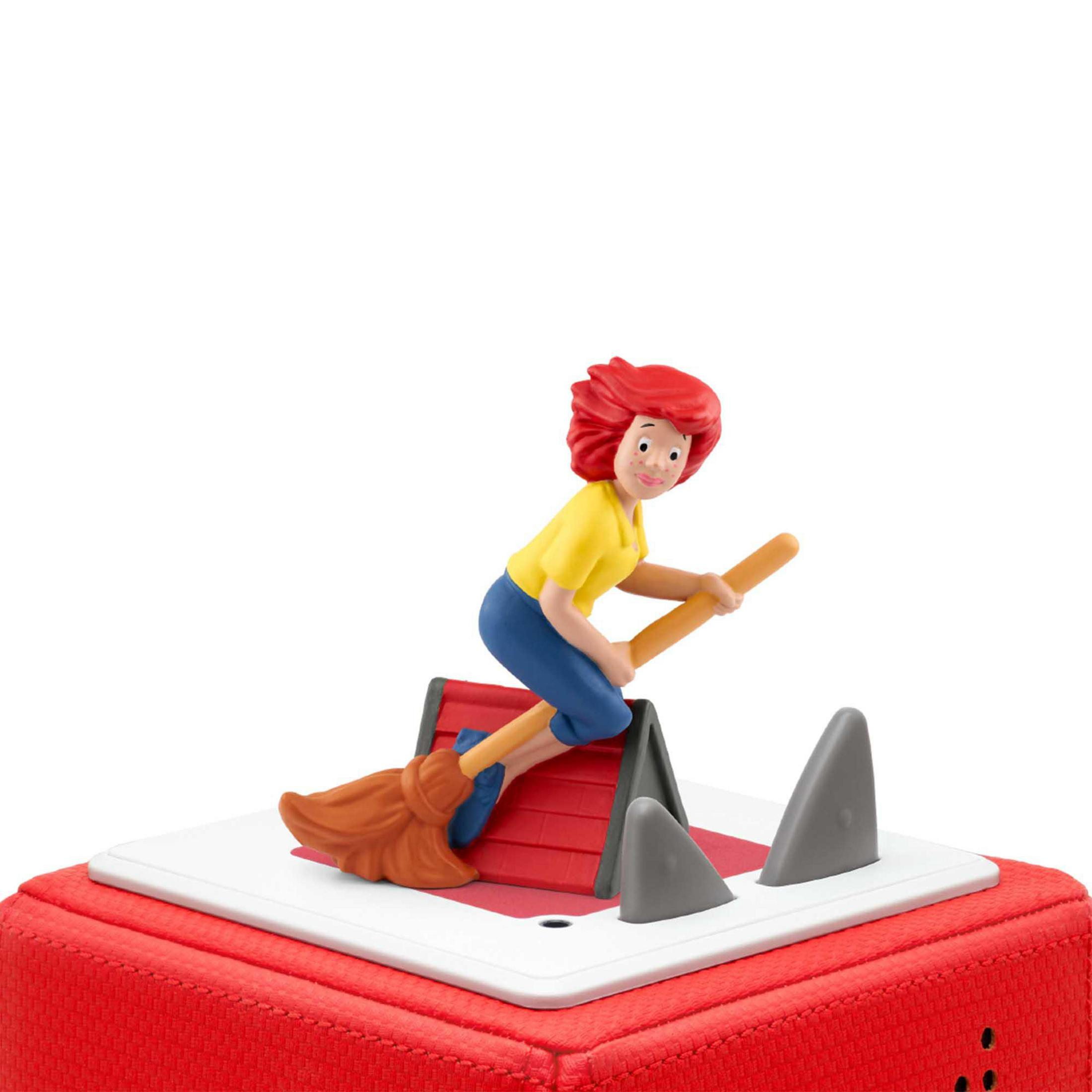 Cartoonfigur auf einem Besen, der über einem roten Block mit grauen Formen fliegt. Weißer Hintergrund.